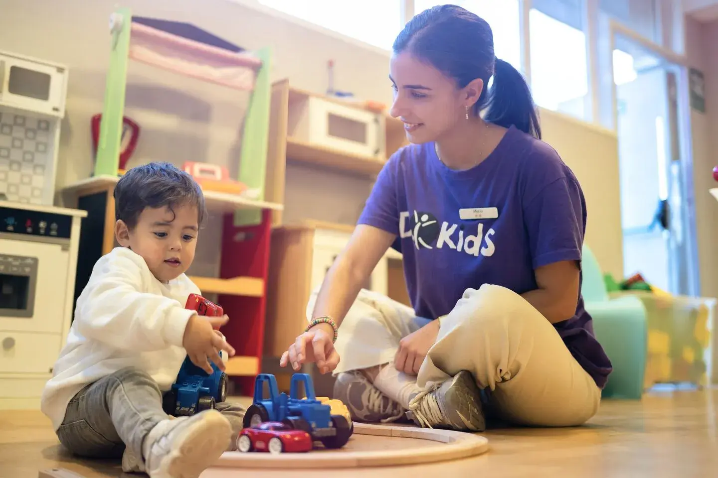 Our crèche staff playing with a toddler