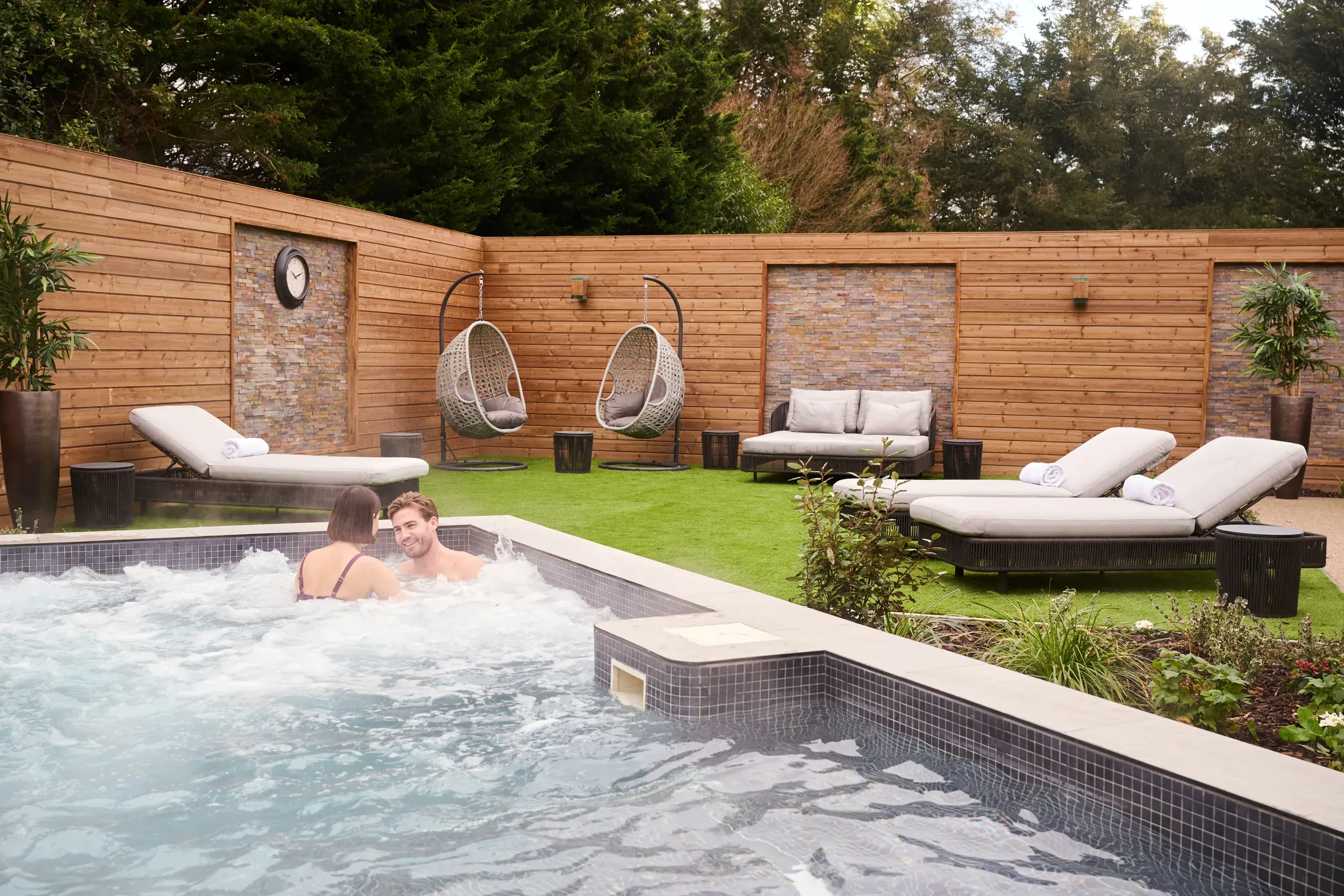 Two people relaxing in the tranquil surroundings of our Spa Garden