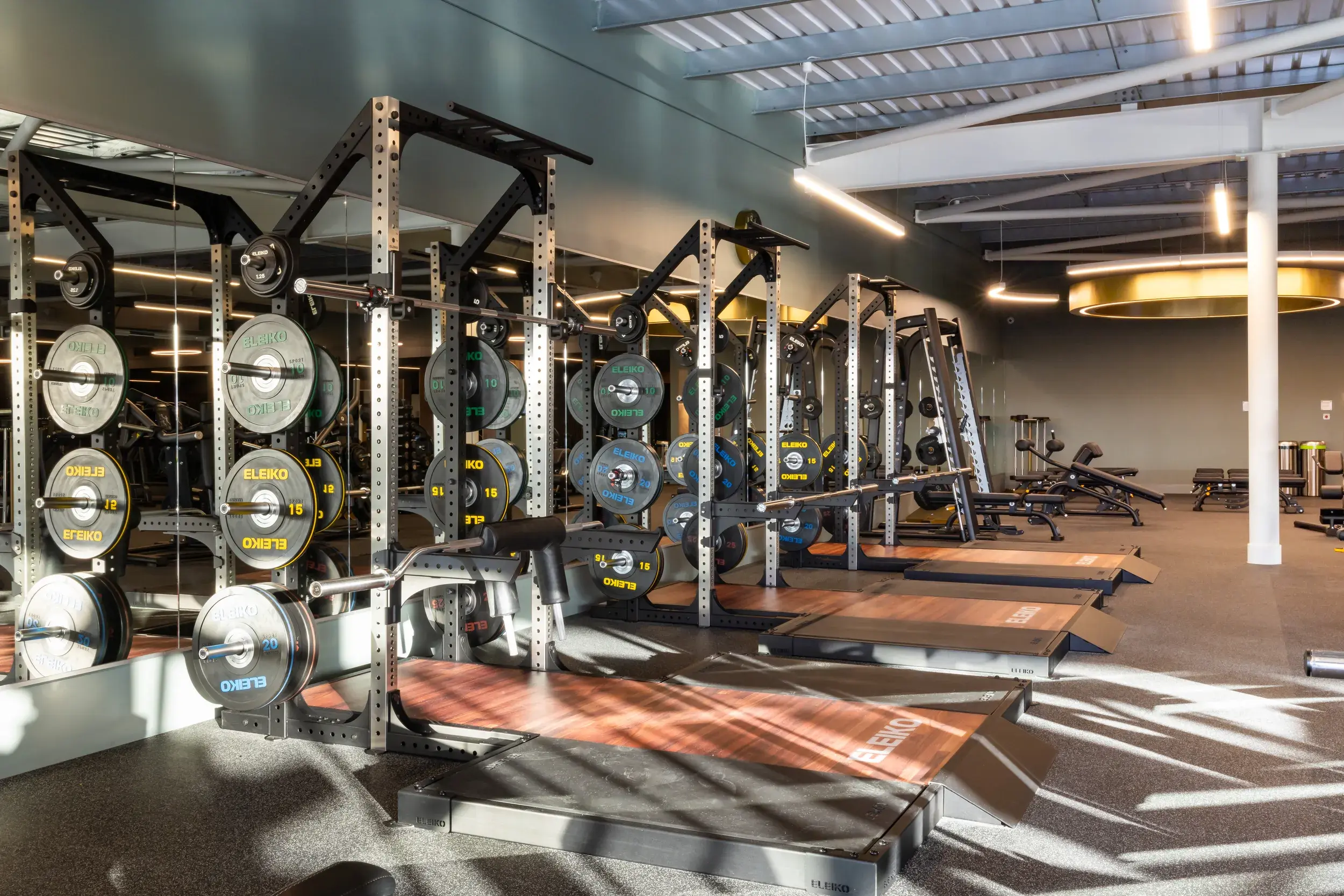A rack of weights and Olympic lifting platforms
