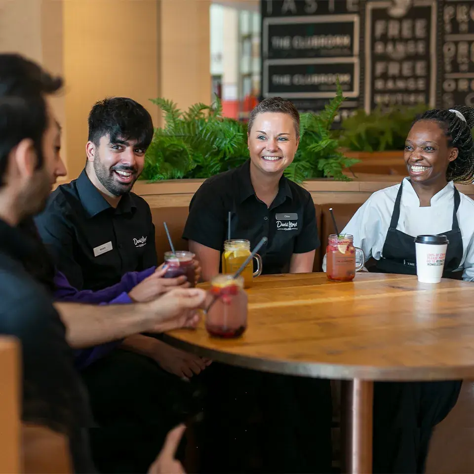 David Lloyd team members sitting round a table