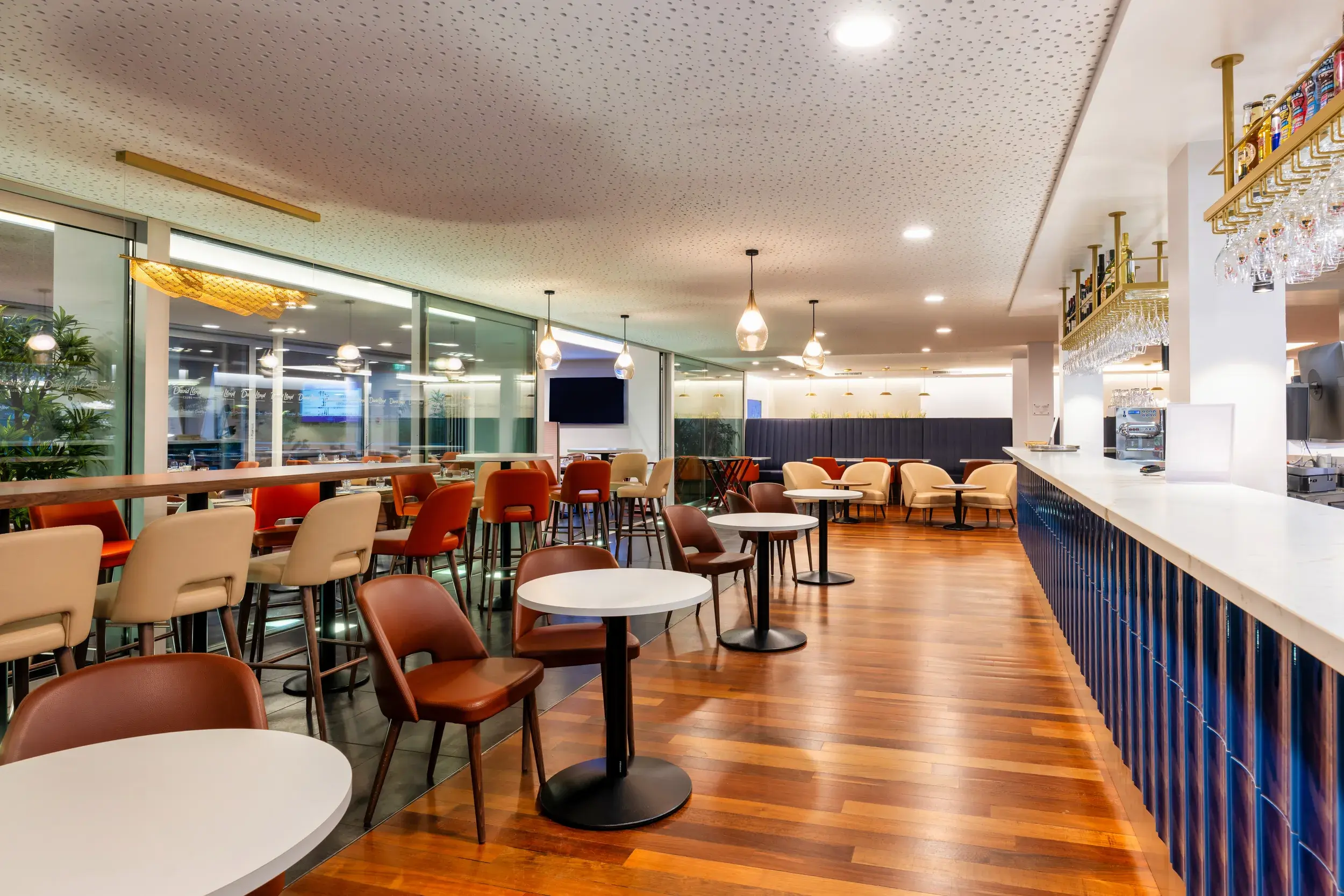 Two women enjoying a drink and a chat in the Clubroom