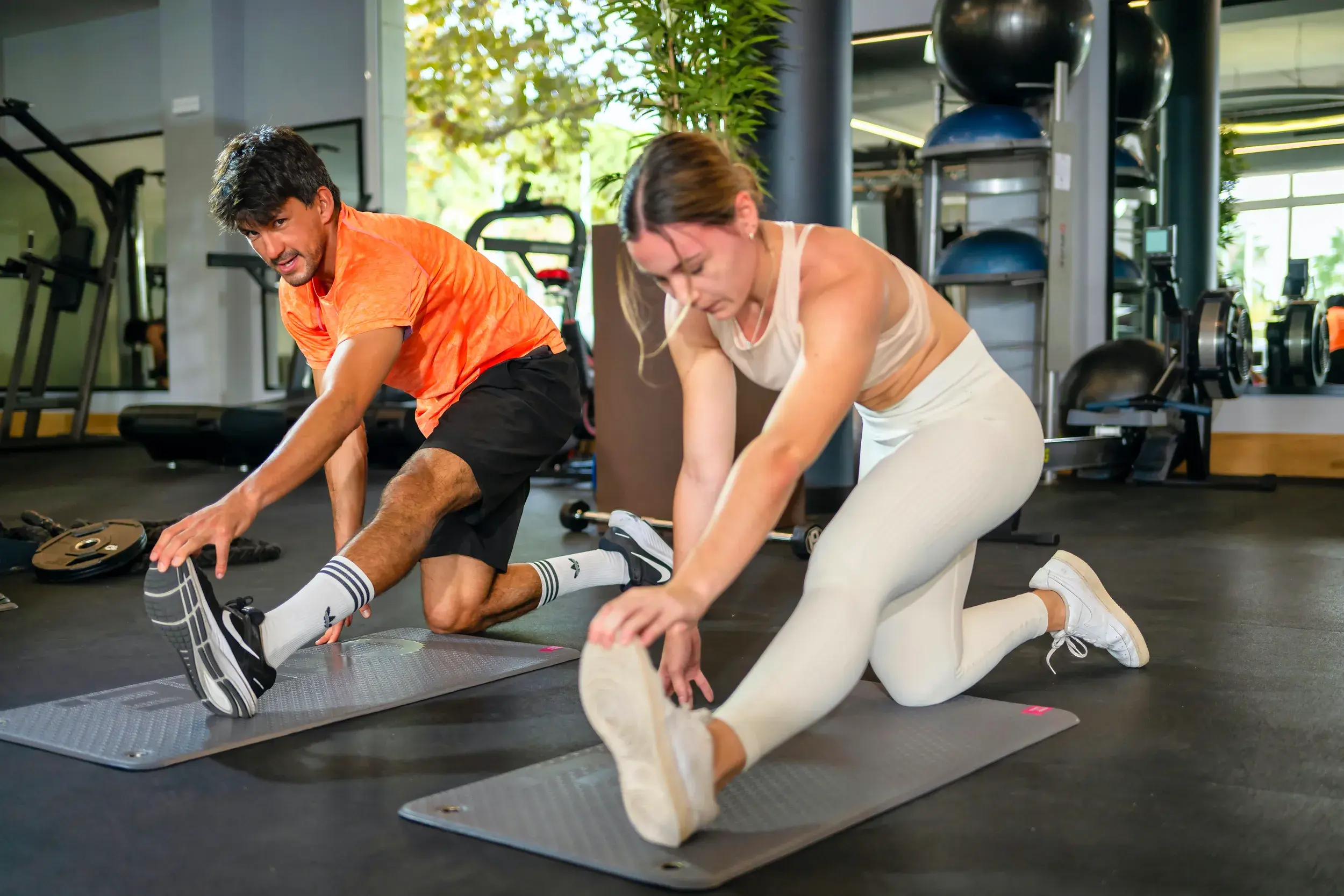Three people running on a treadmill