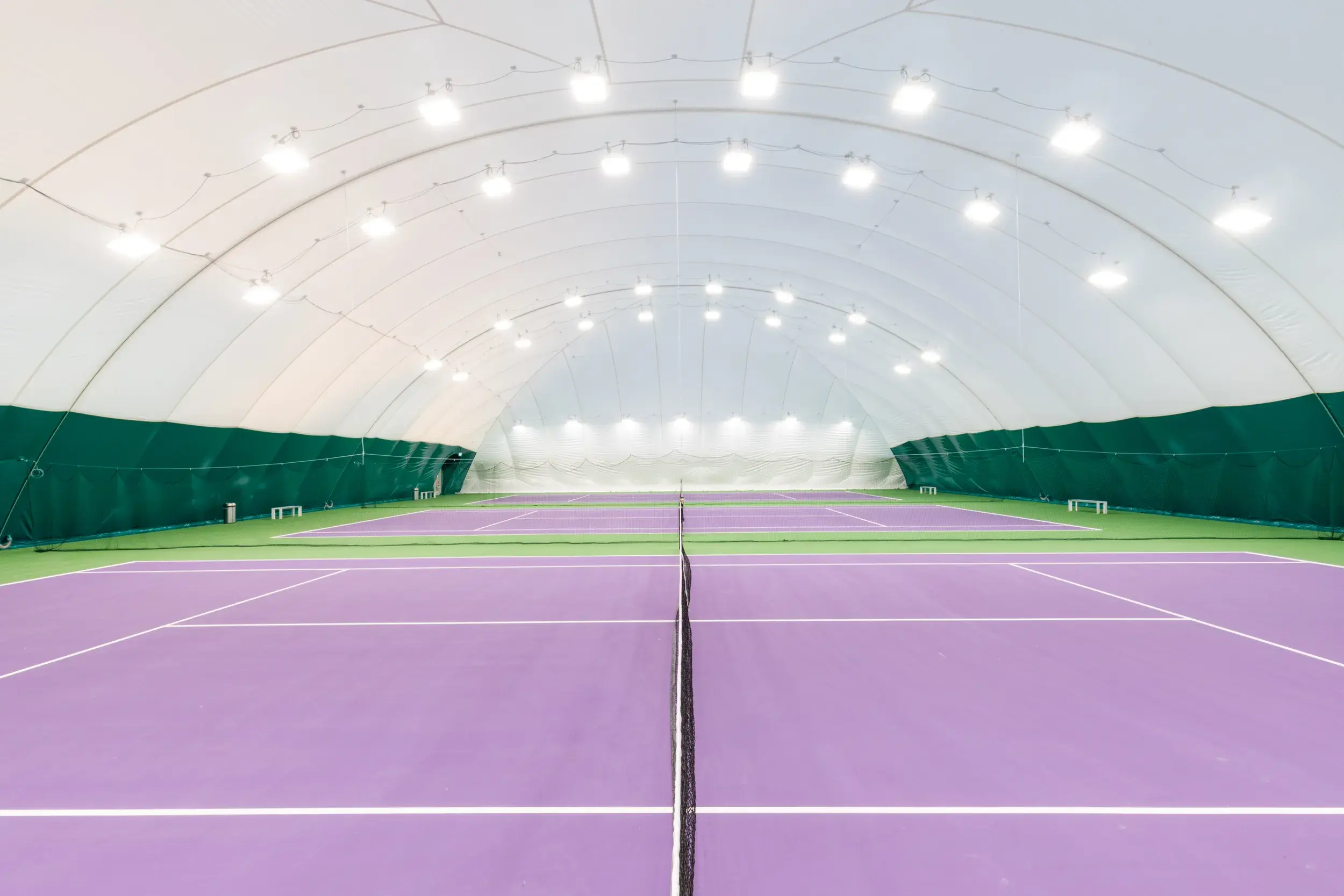 outdoor tennis court covered by a dome 
