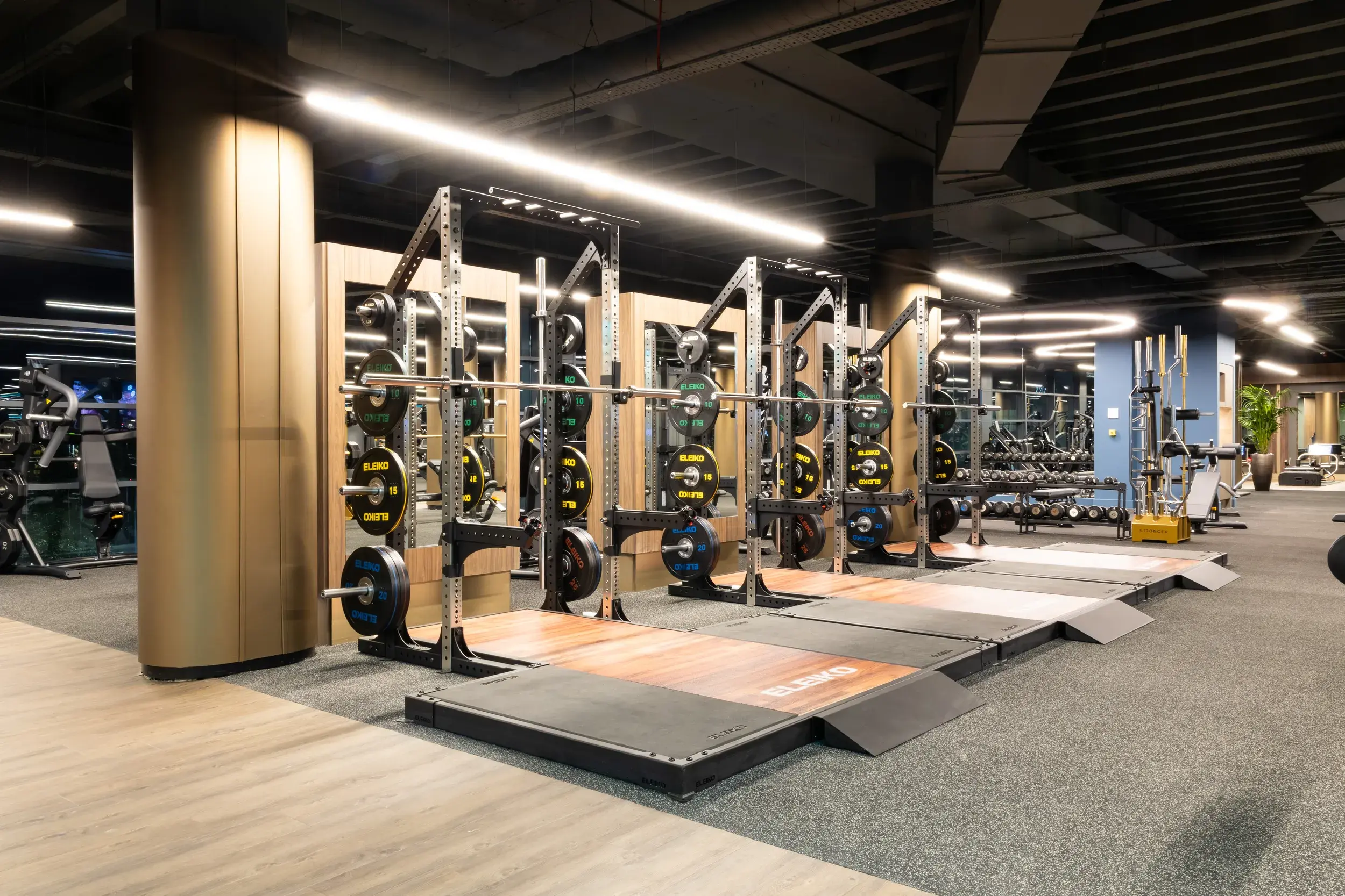 A rack of weights and Olympic lifting platforms
