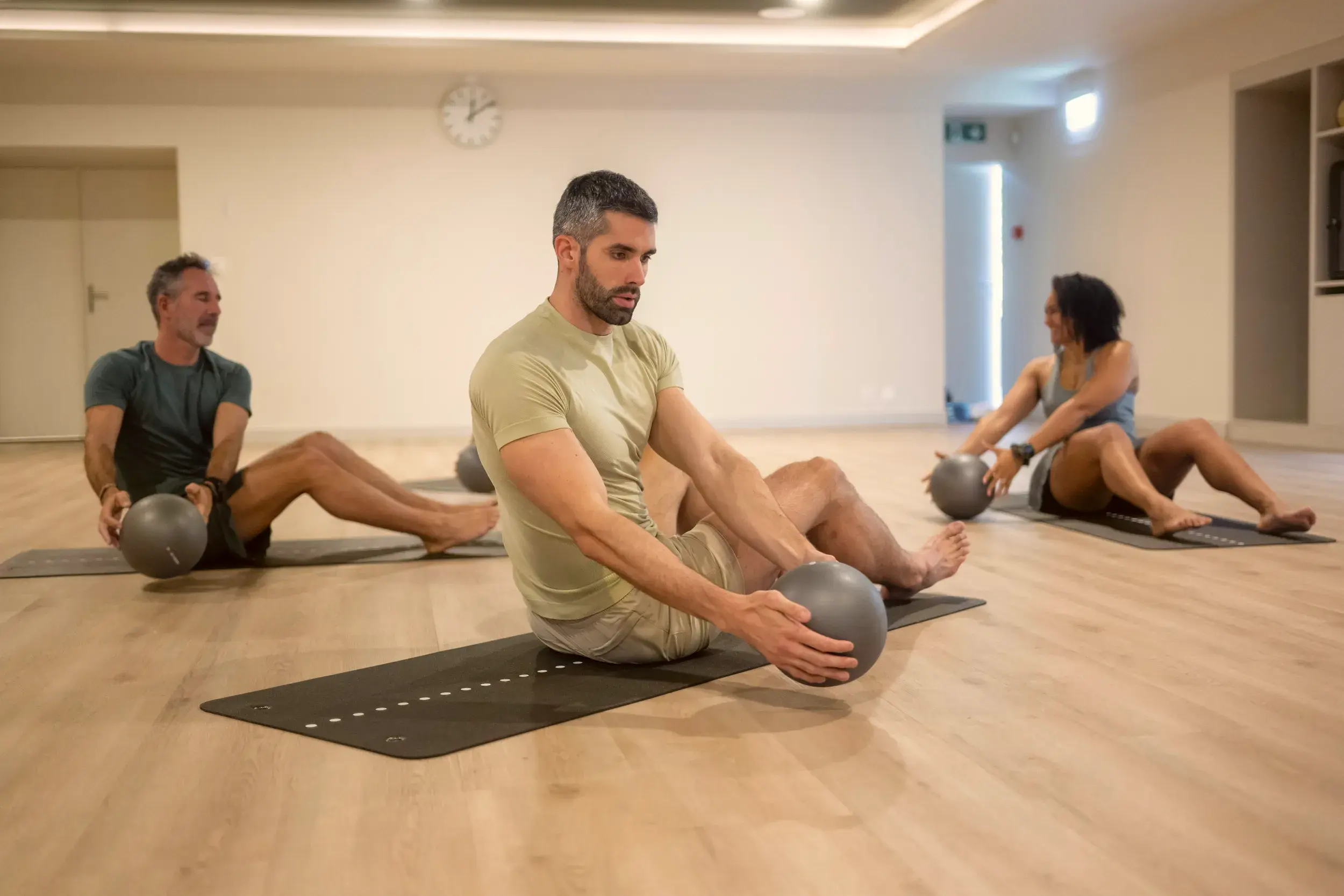 A man on the floor doing mat pilates
