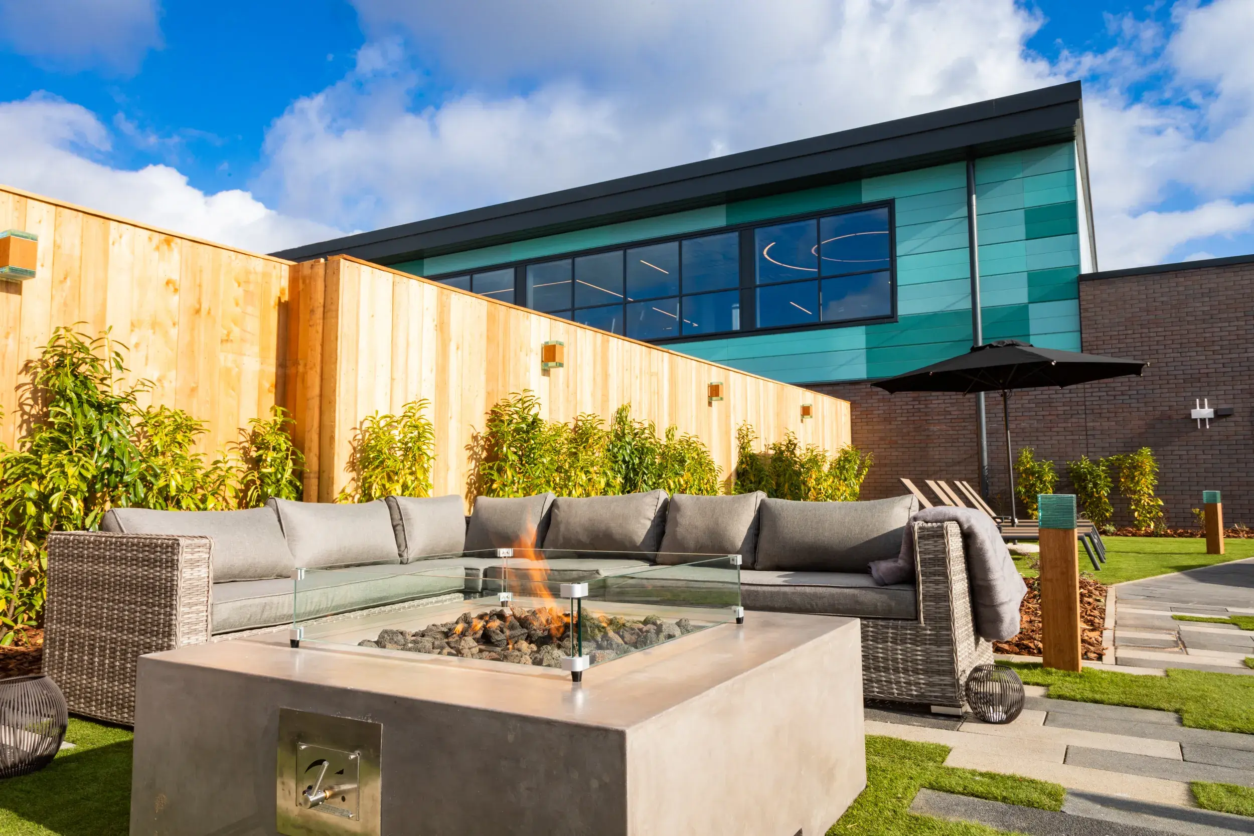 Comfy chairs and warming firepit in our Spa Garden