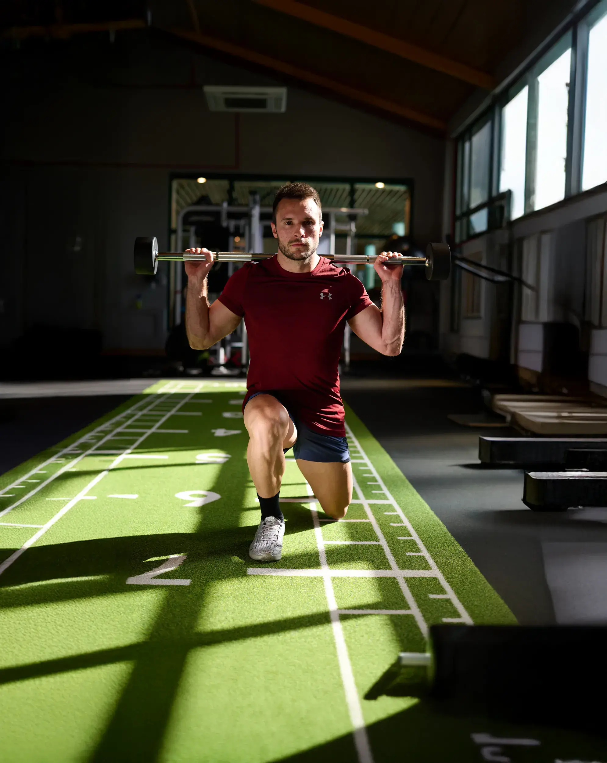 A man doing squats with a bar