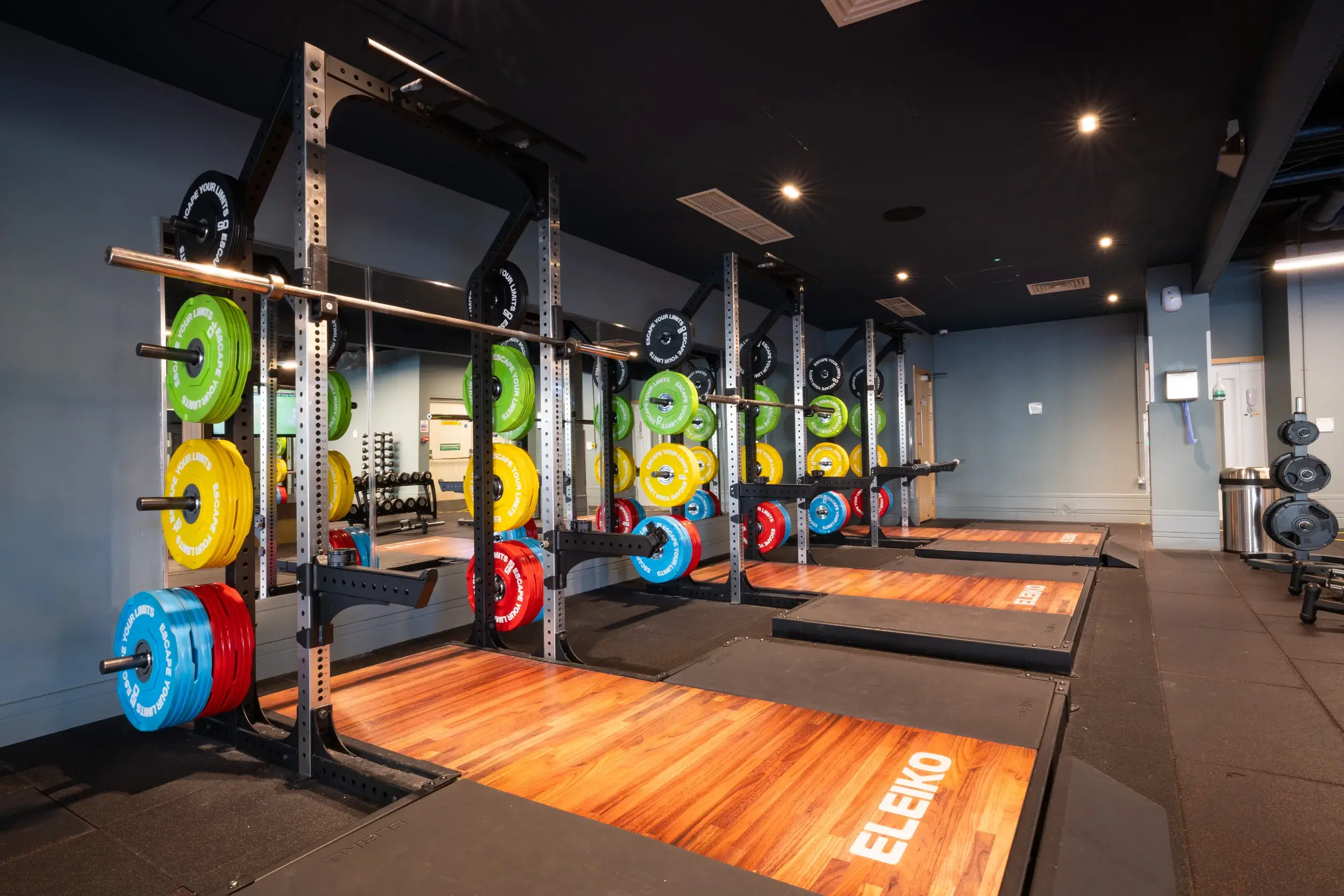 A rack of weights and Olympic lifting platforms