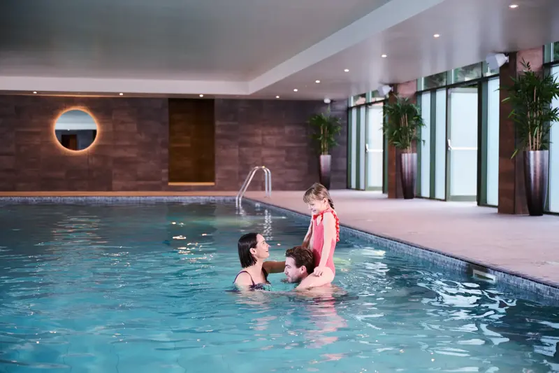 A family in the indoor pool