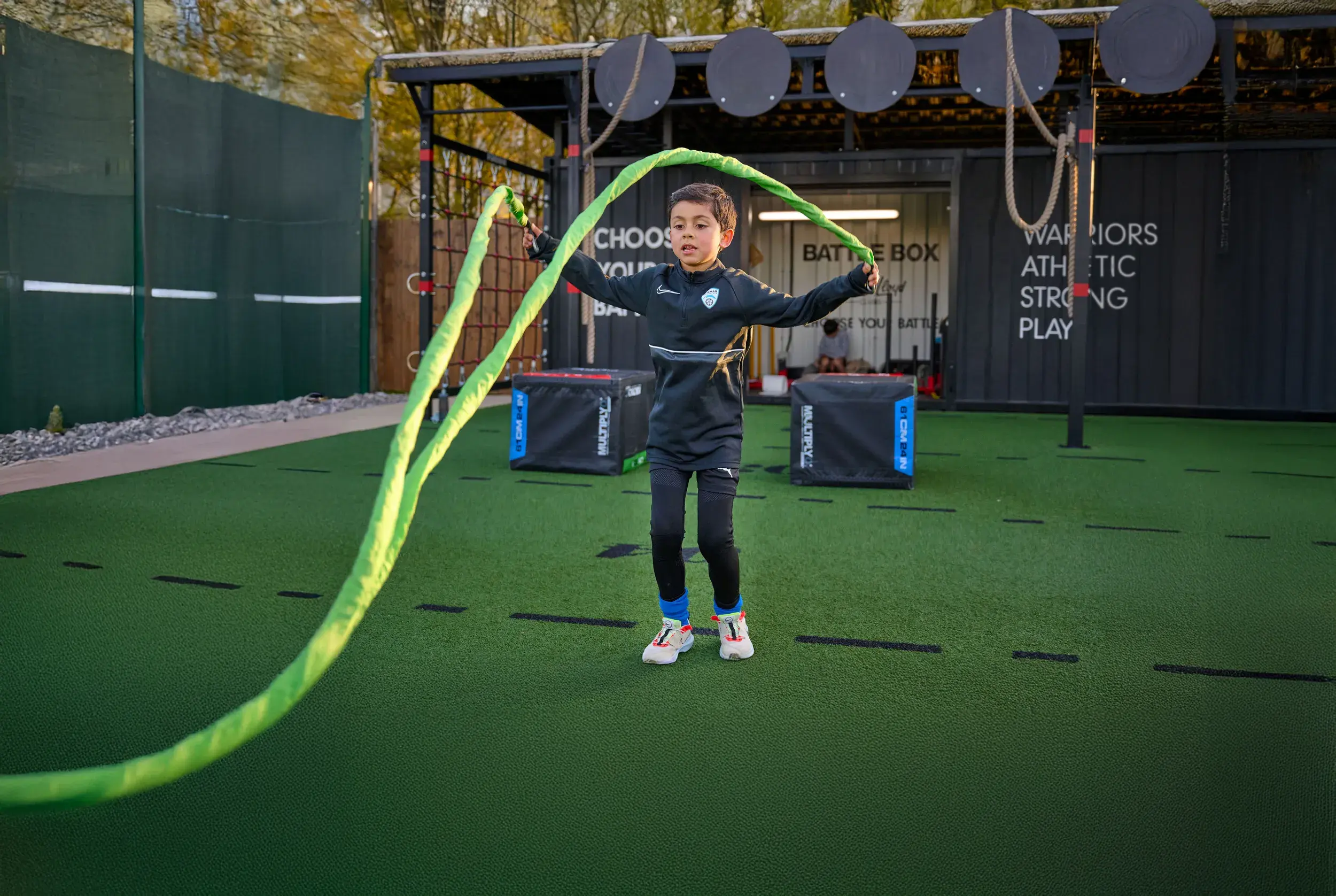 A young boy holding battleropes in a Rebels Battlebox class