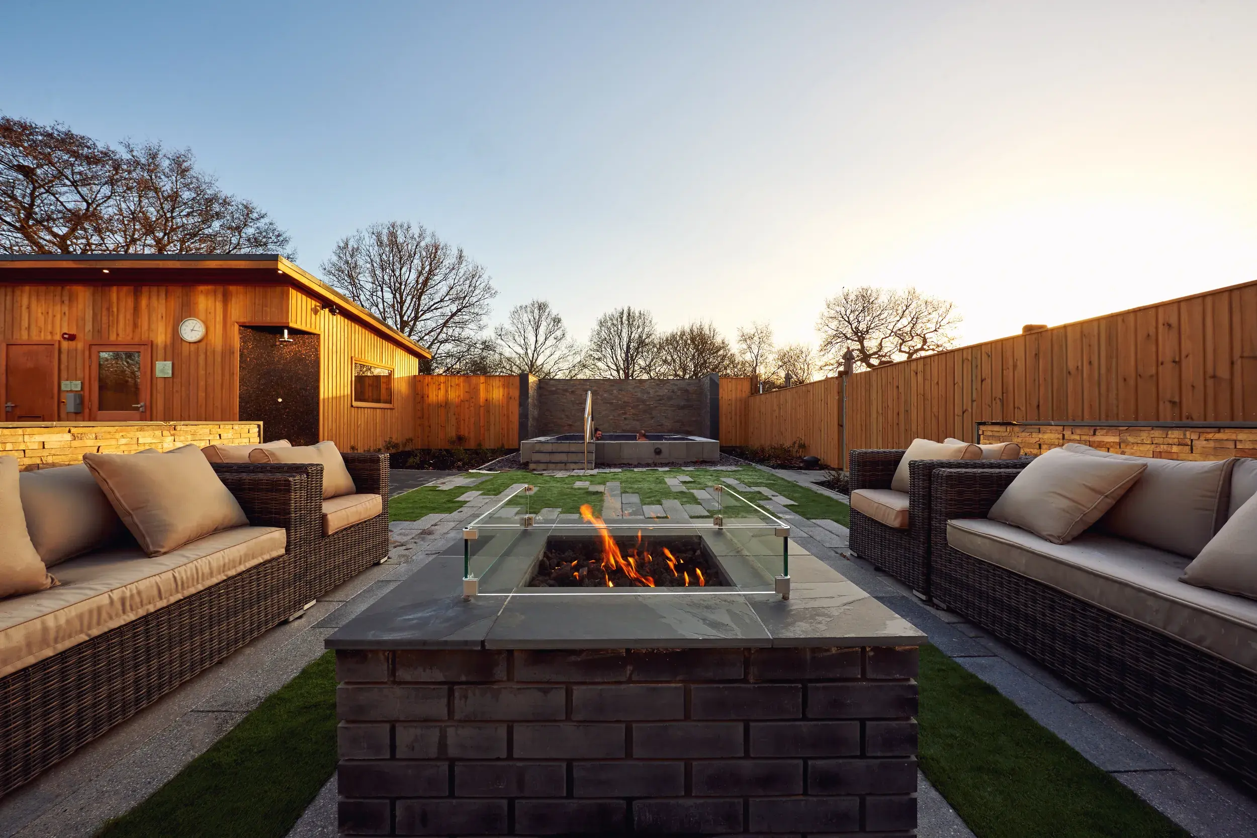 Sofas surround a fire pit in the Spa Garden