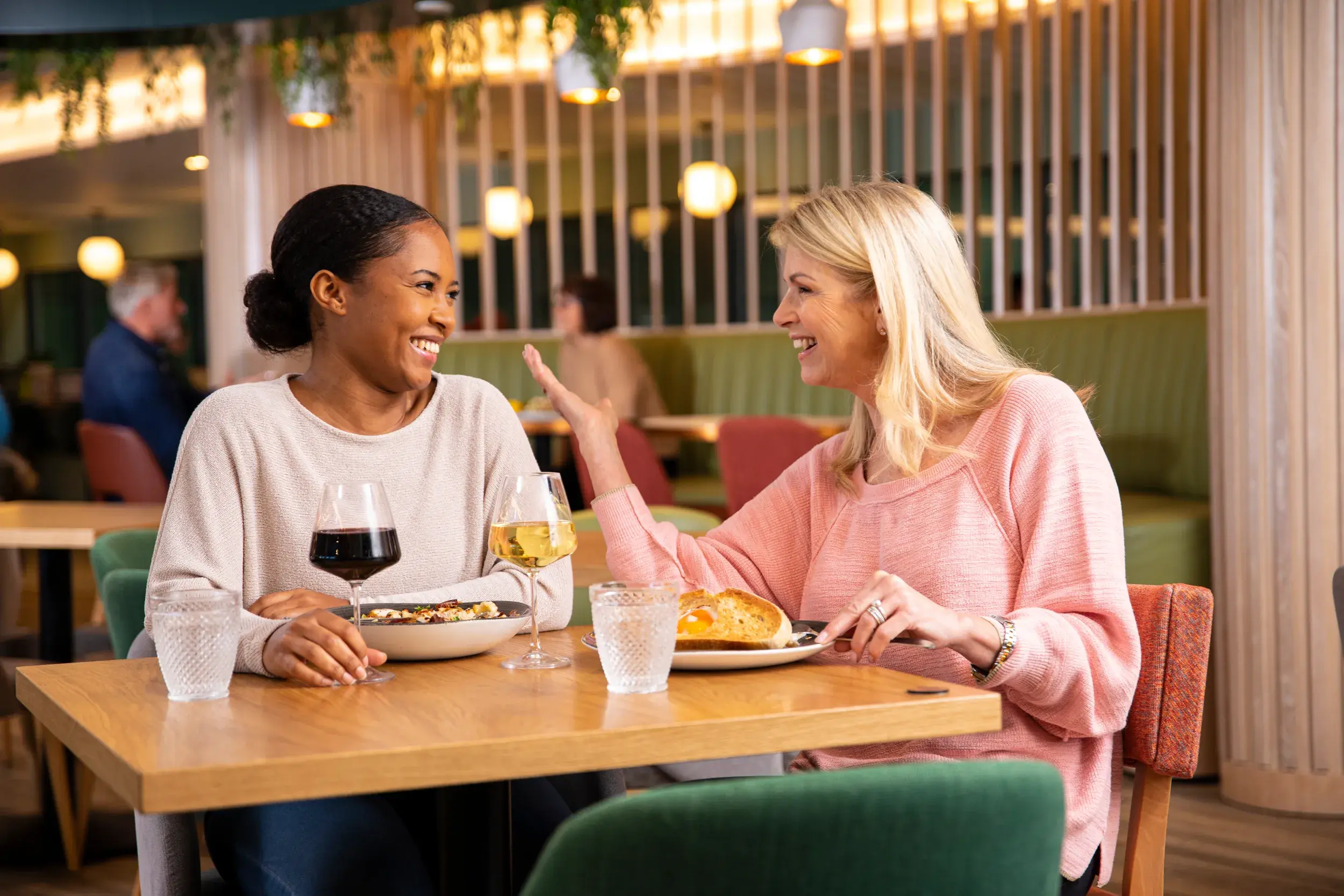 Two women chatting over a meal at David Lloyd
