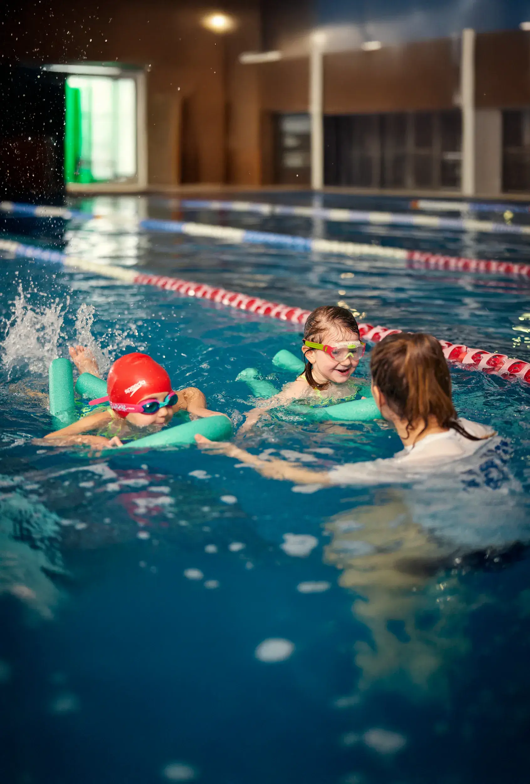 Two kids having a swimming lesson