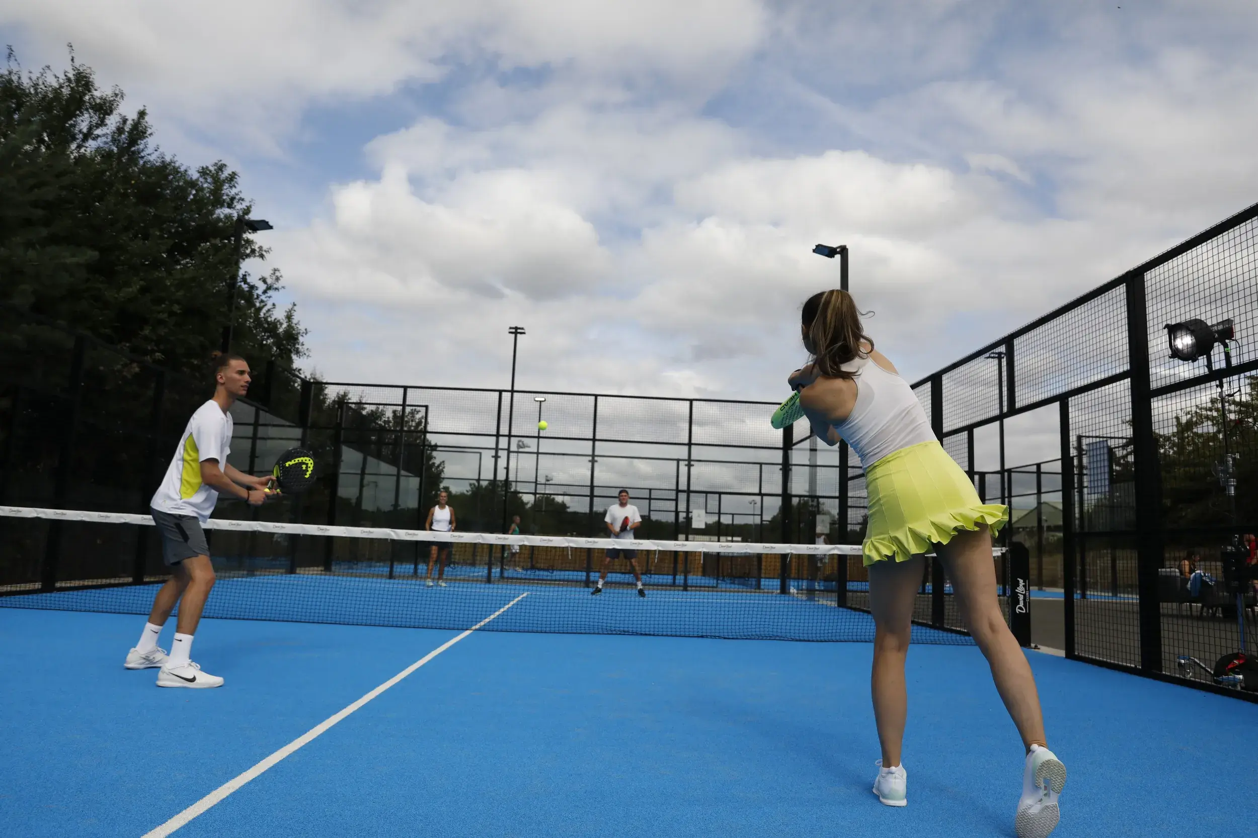A woman playing Padel on an outside court