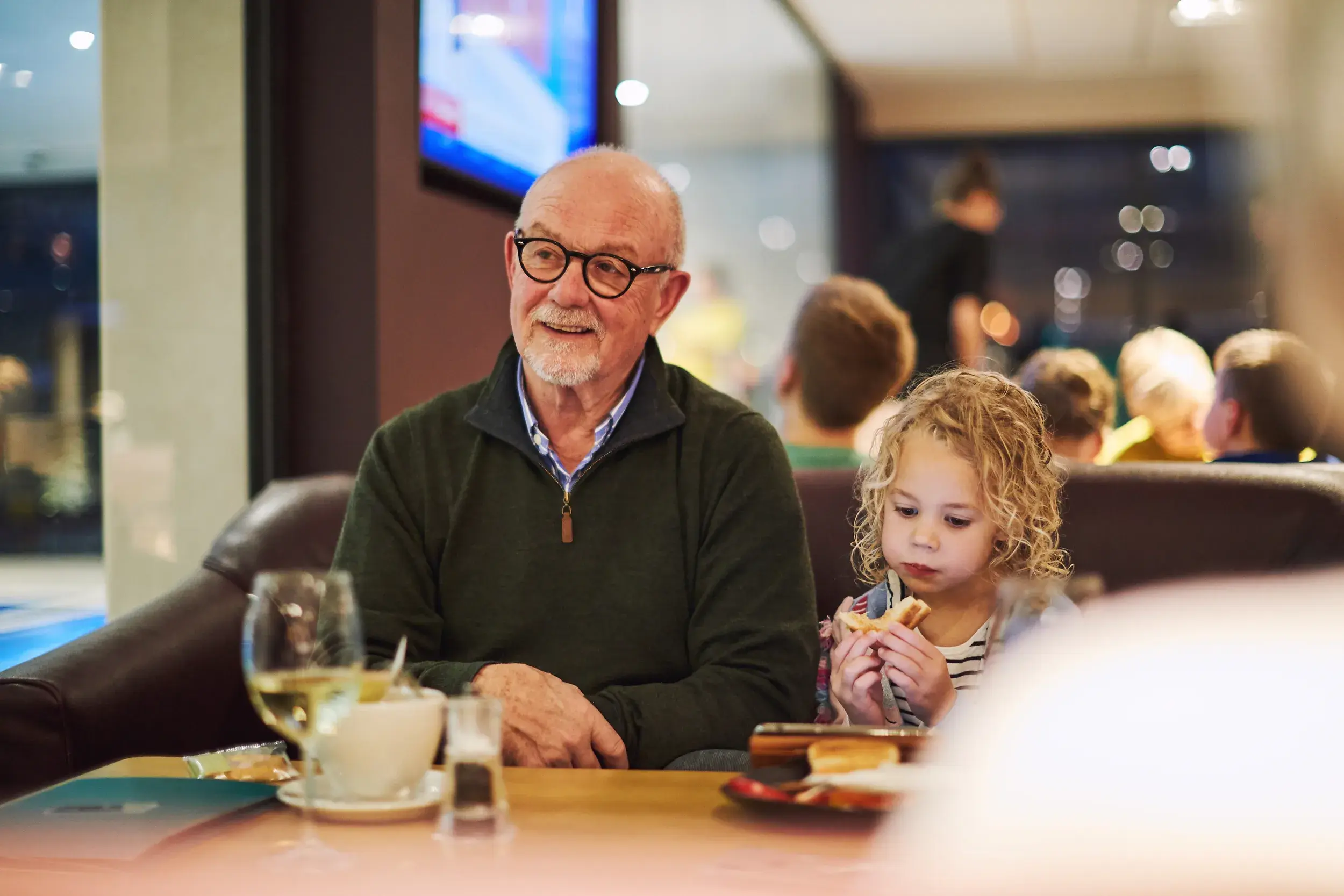 A family with a young boy enjoying a meal