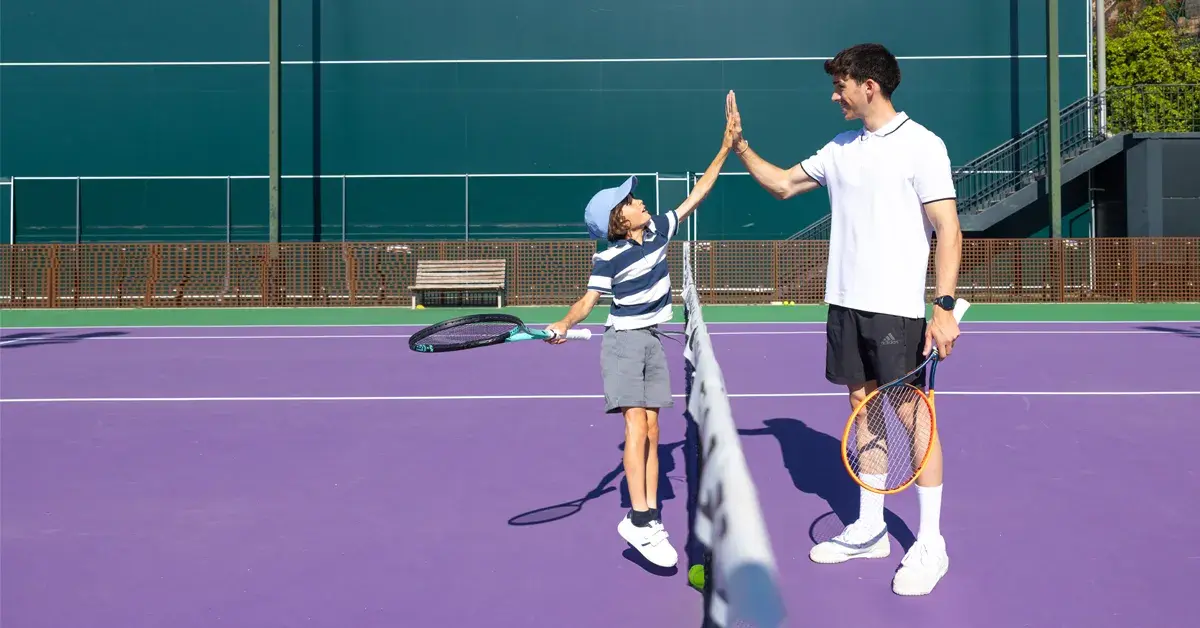 Children jumping holding tennis racquets