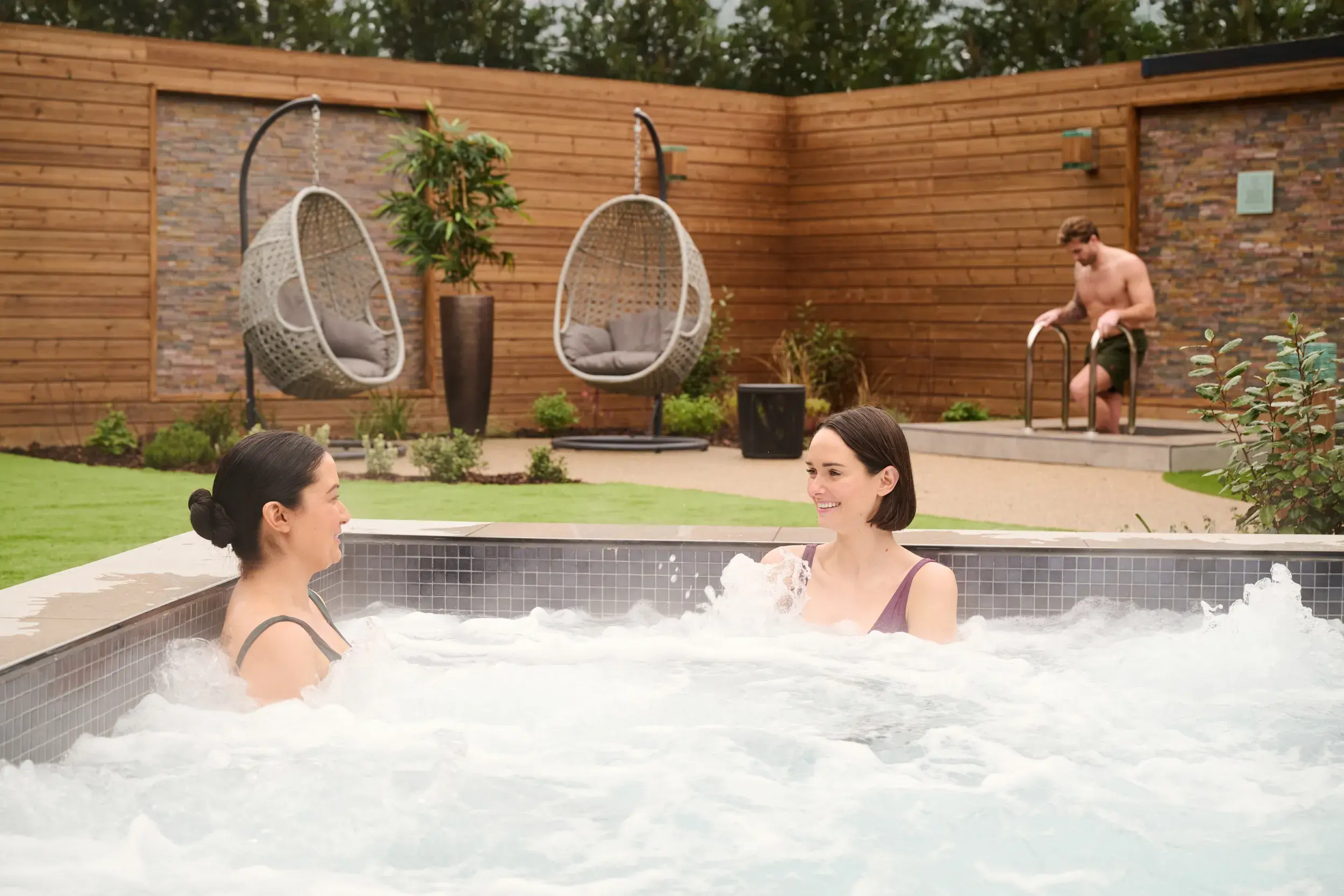 Two people relaxing in the tranquil surroundings of our Spa Garden