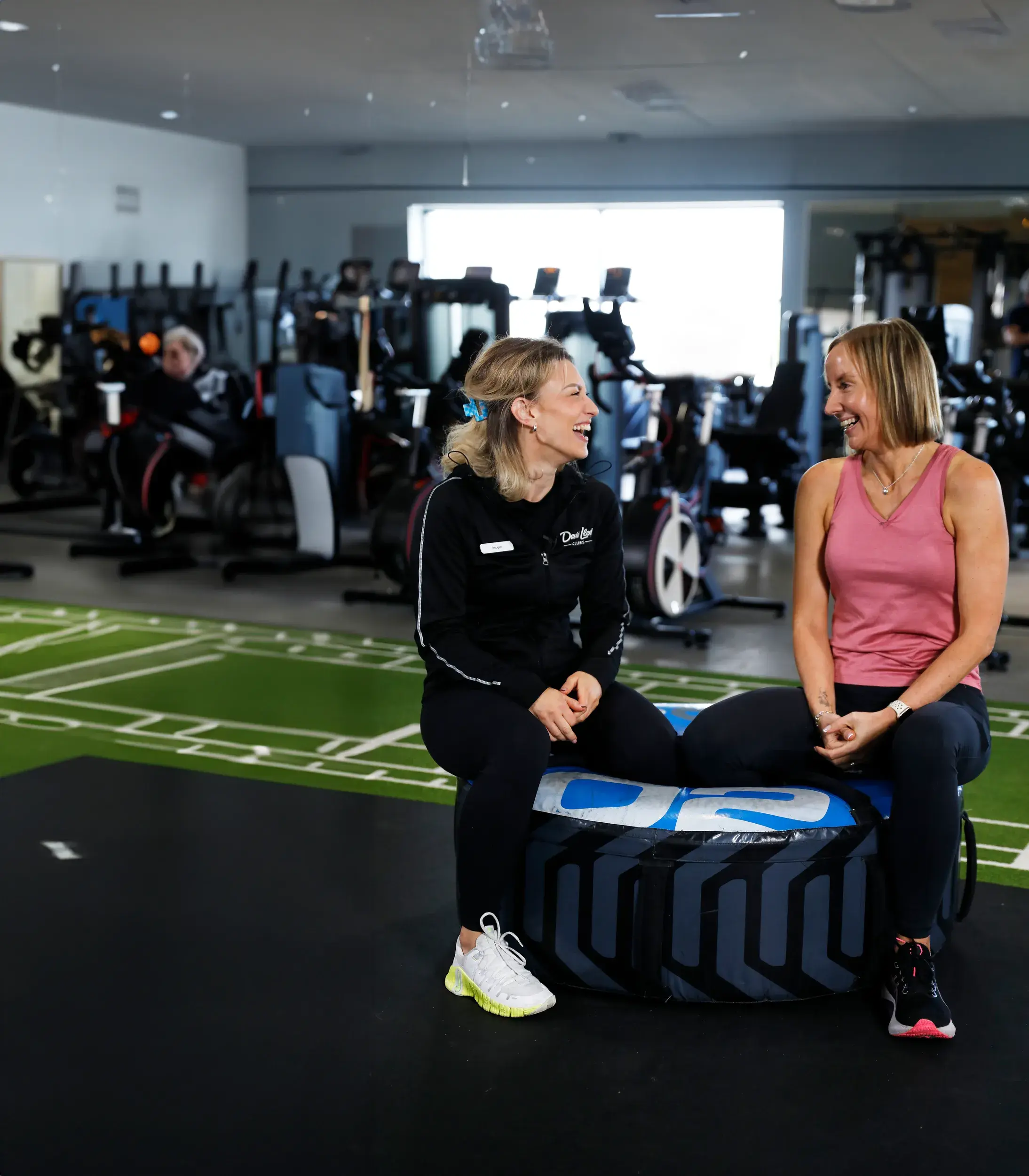 Two women chatting during a PT session