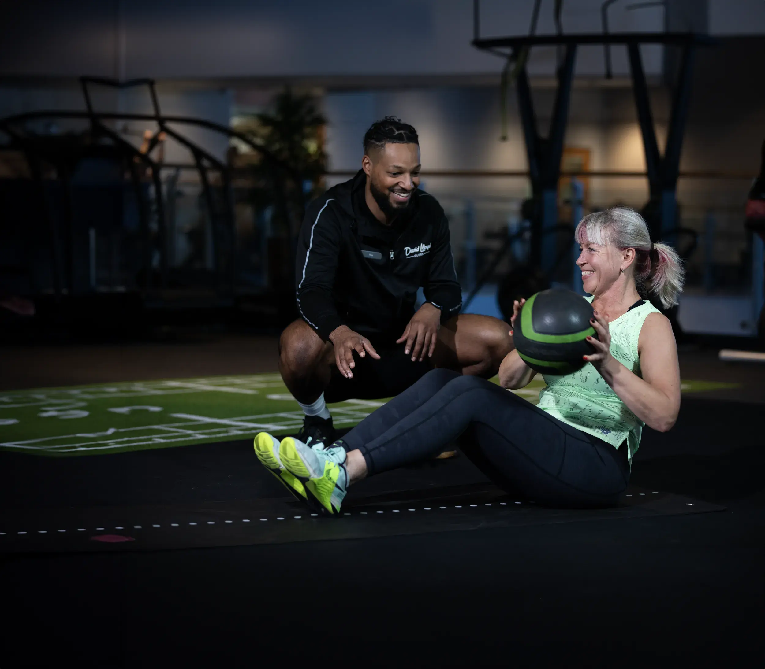 A woman exercising with her personal trainer