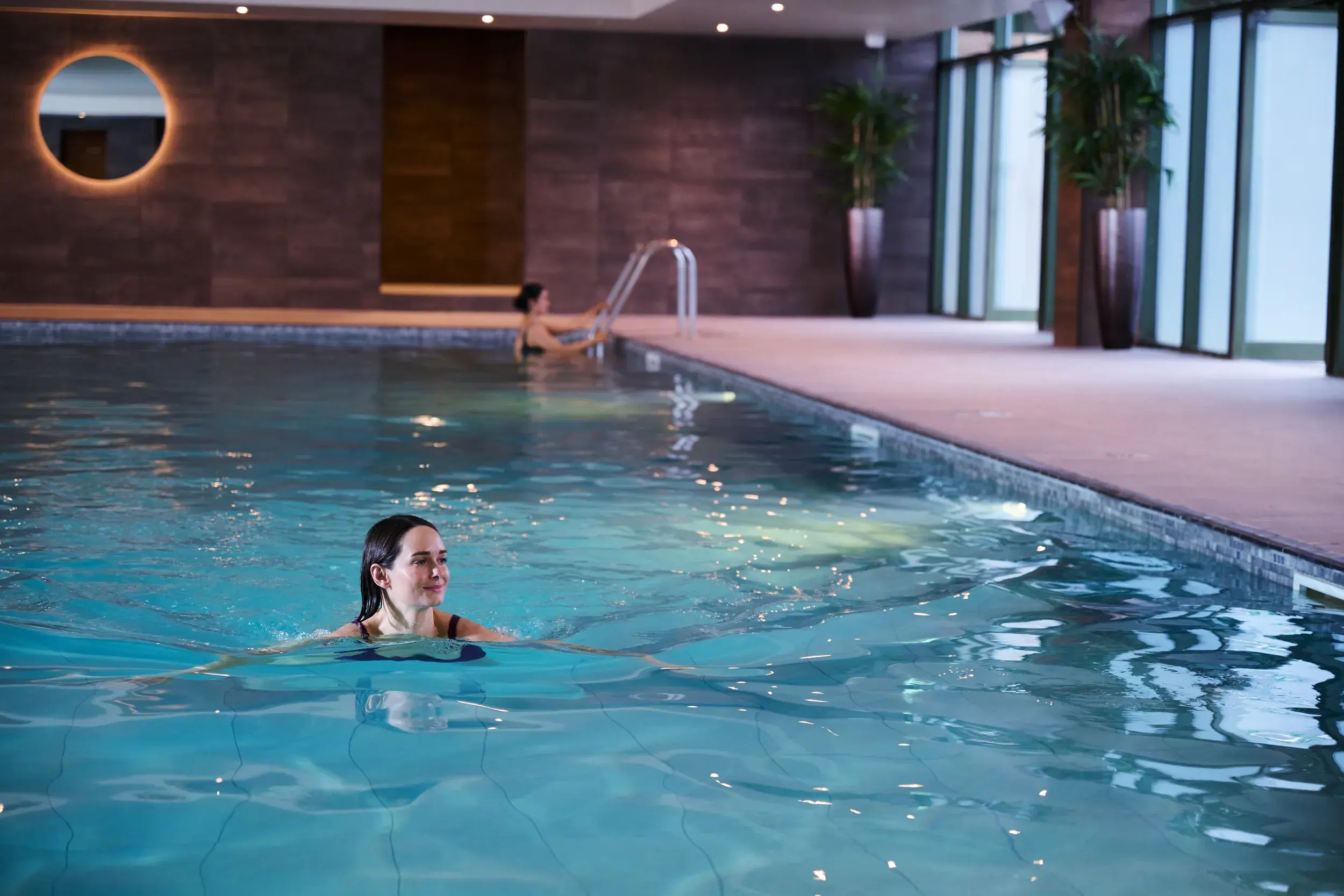 A woman swimming in an indoor pool