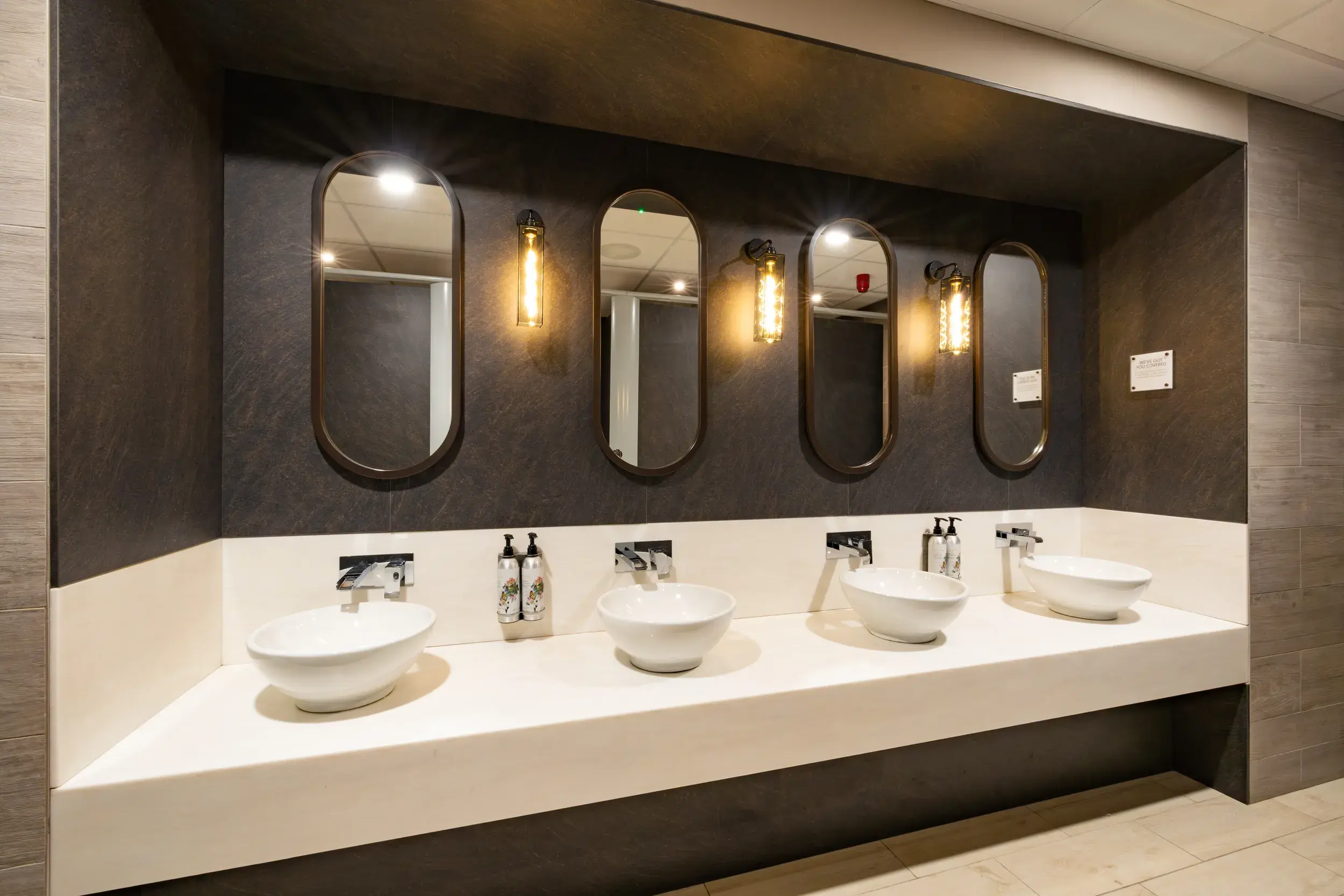 A row of sinks and mirrors 