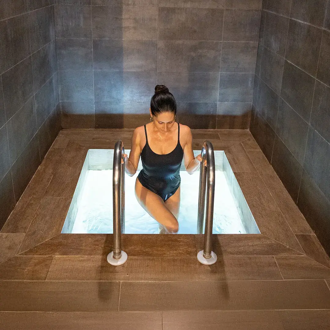 A woman walking out of the plunge pool