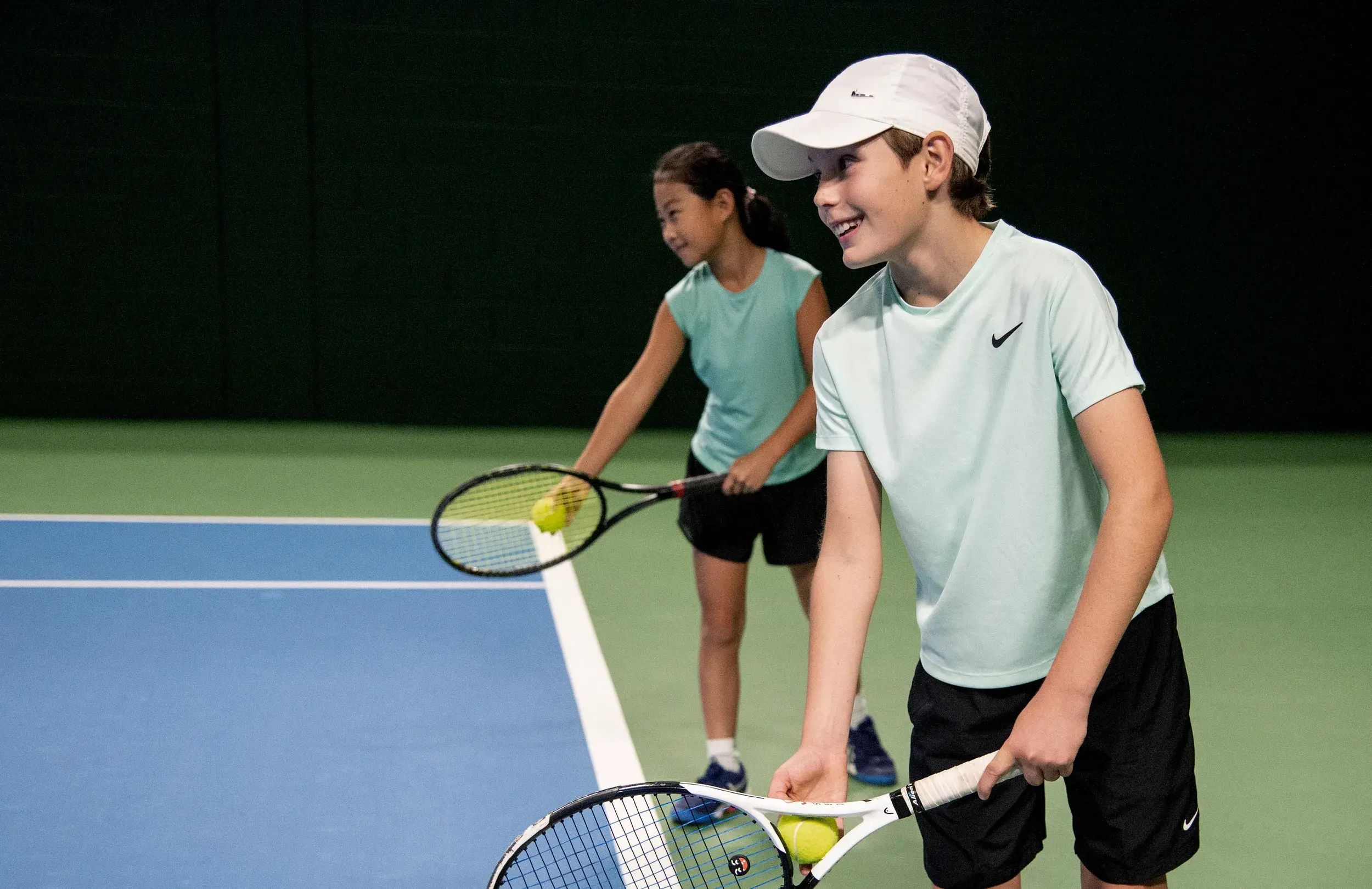 A young boy holding a tennis racquet