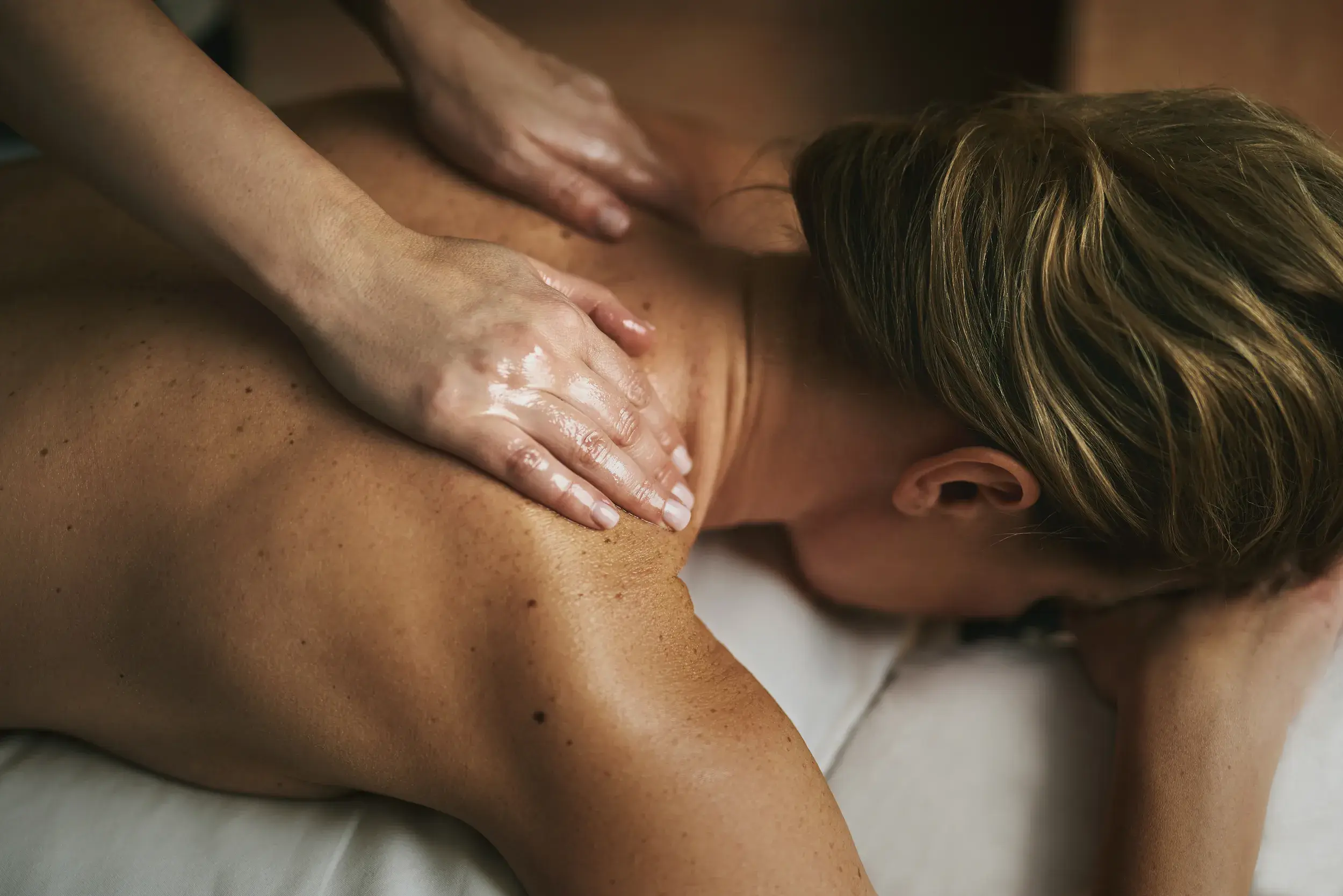 A woman receiving a back massage