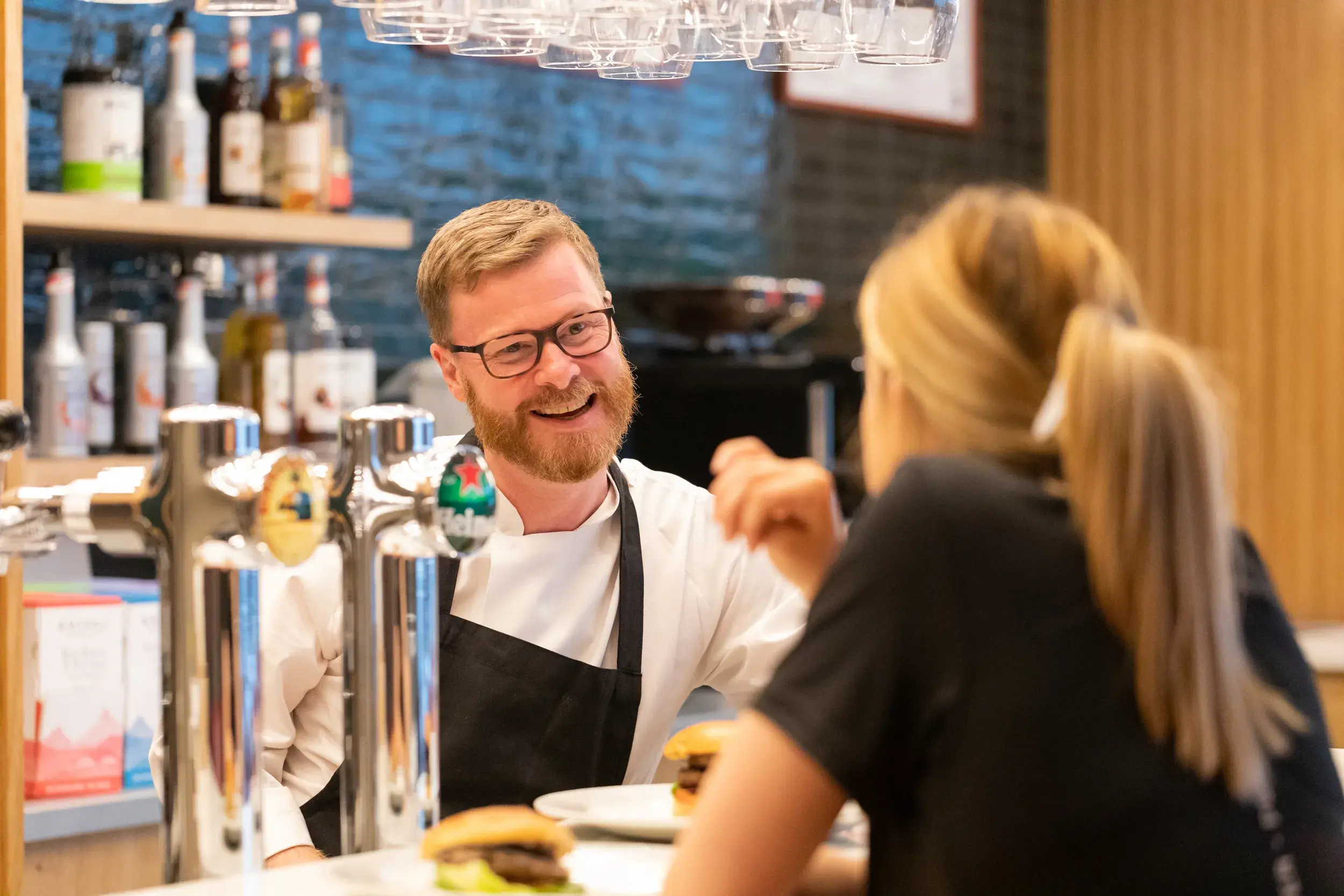 A woman having a conversation with a DL team member at Cricklewood Lane