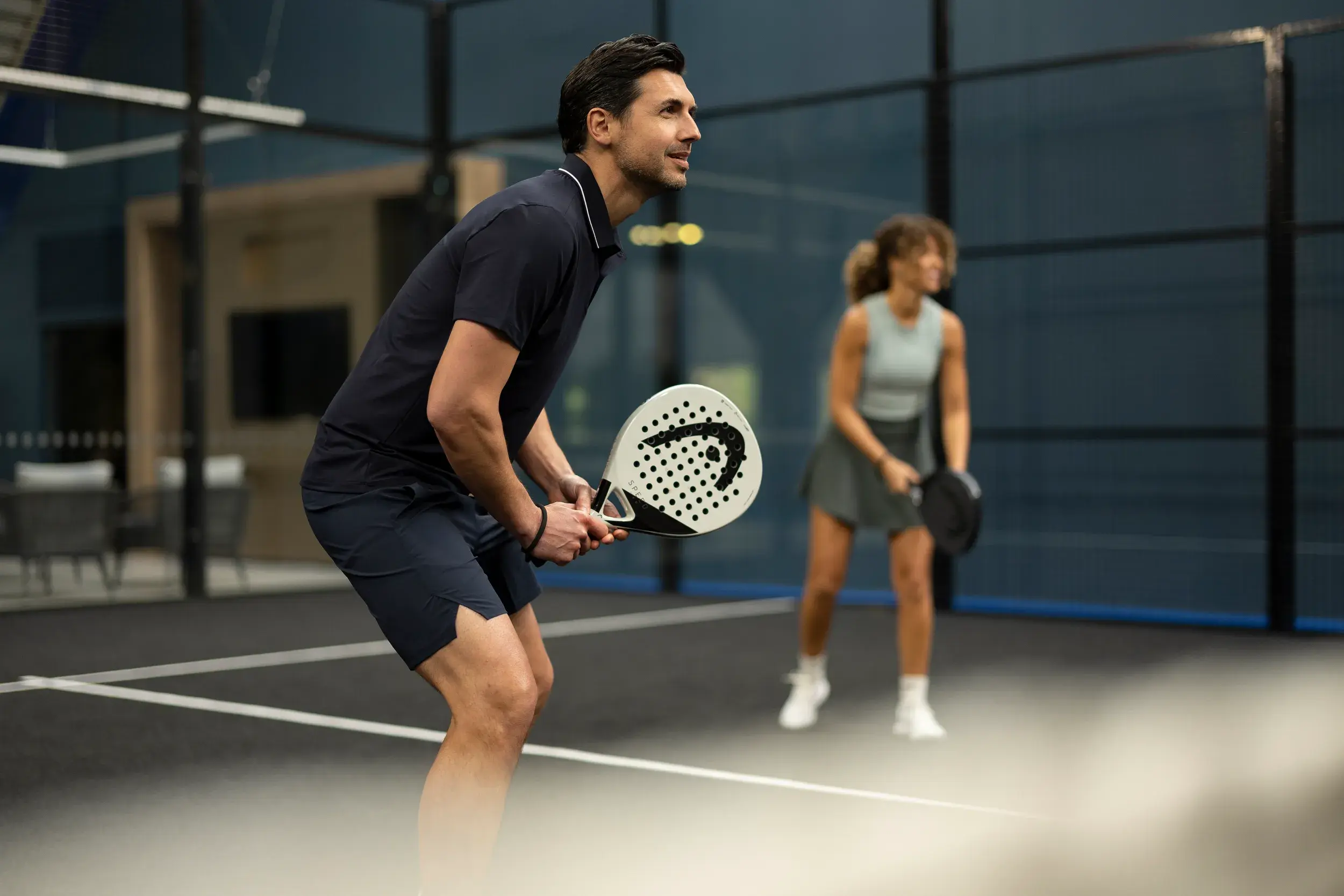 2 people playing a game of Padel