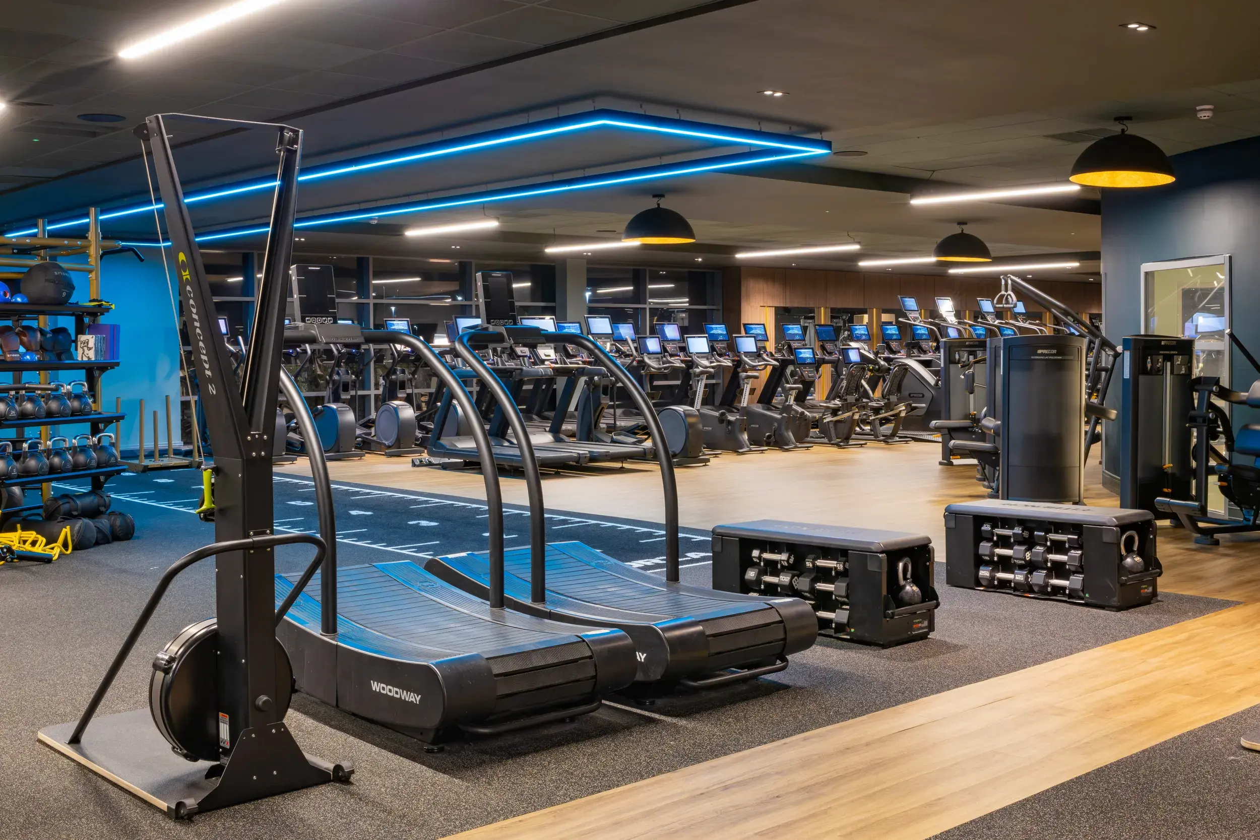 Woodway curve treadmills, weights and treadmills on the gym floor 