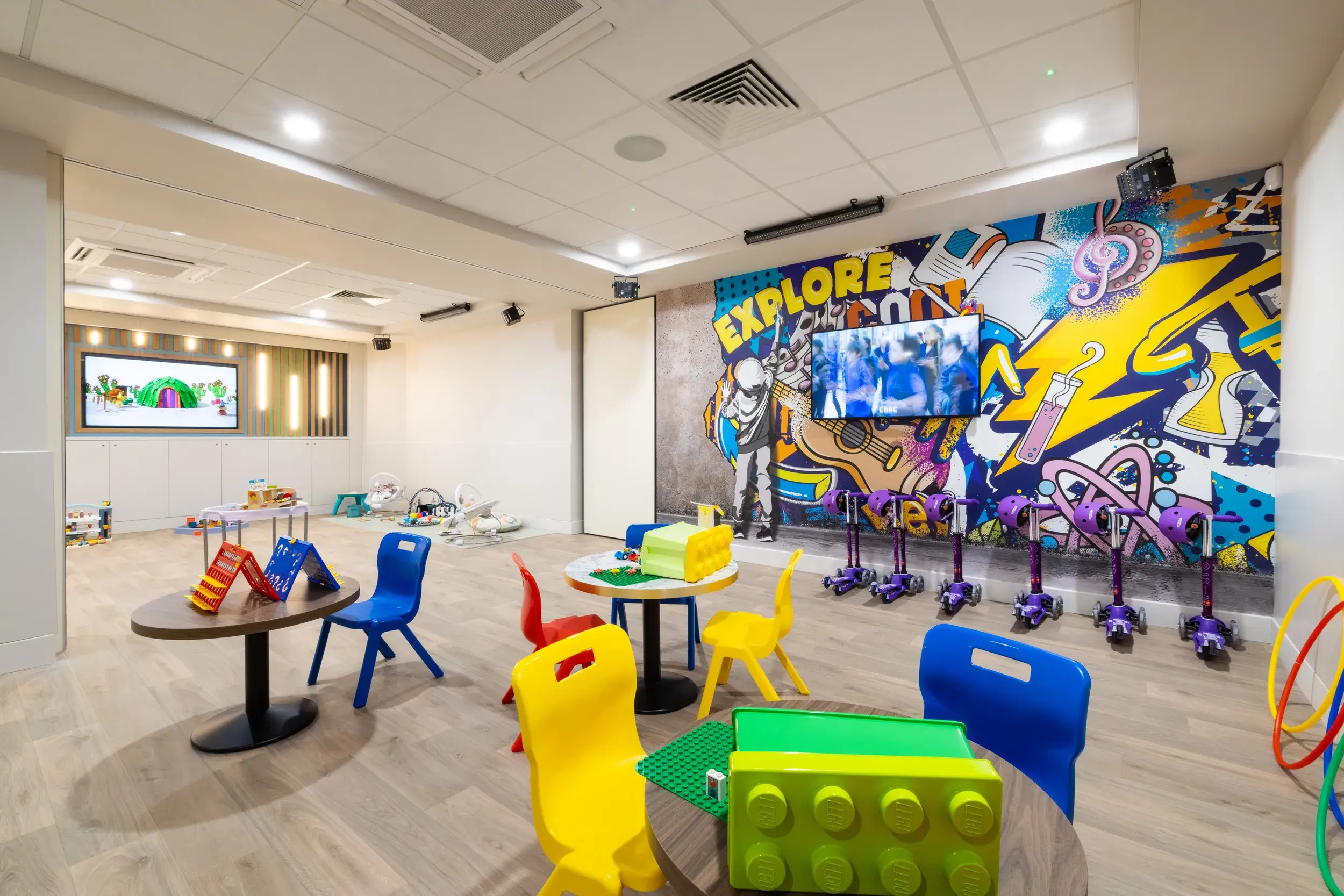 Children playing under a multicoloured tent
