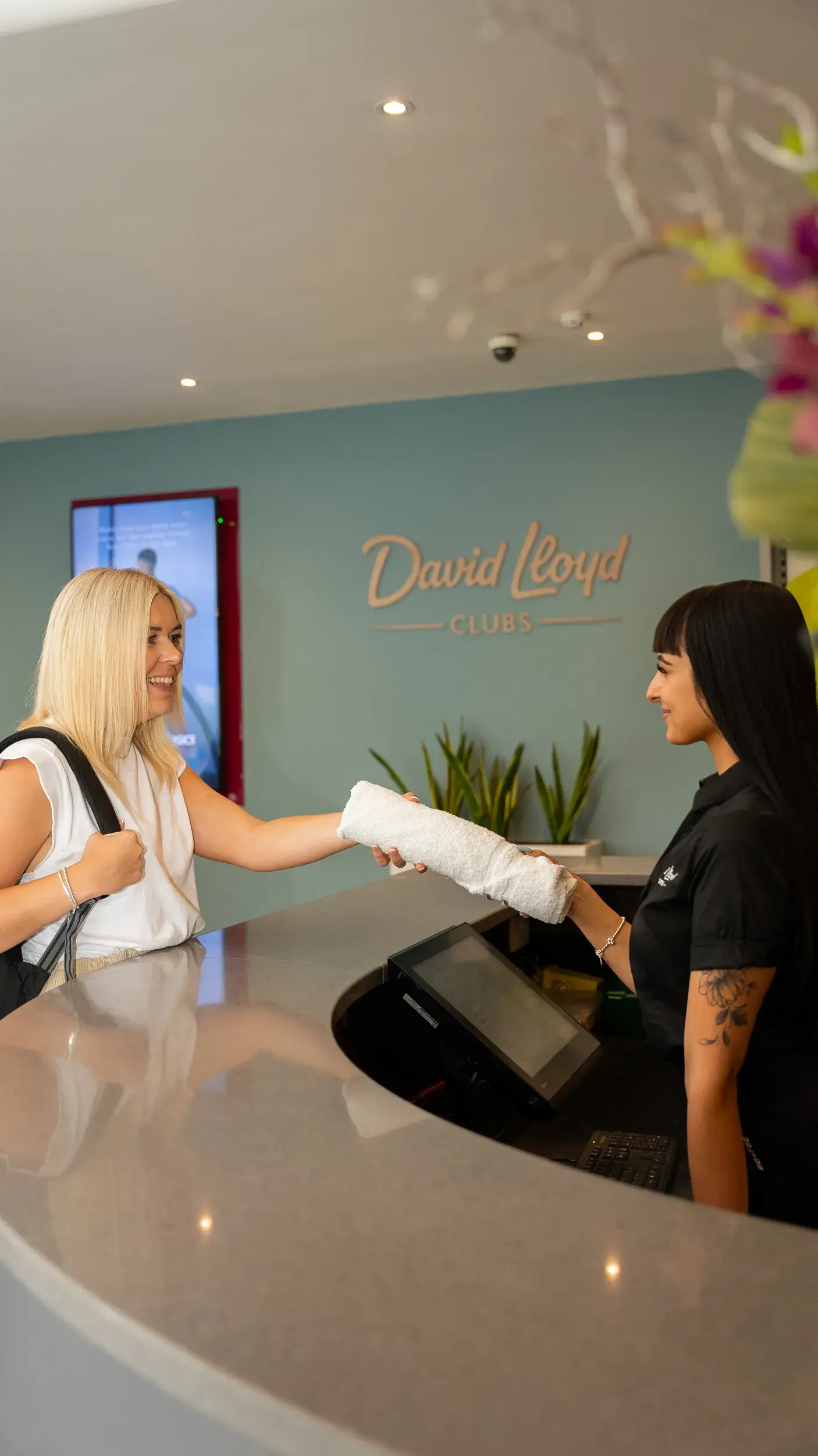 A woman getting a towel from reception