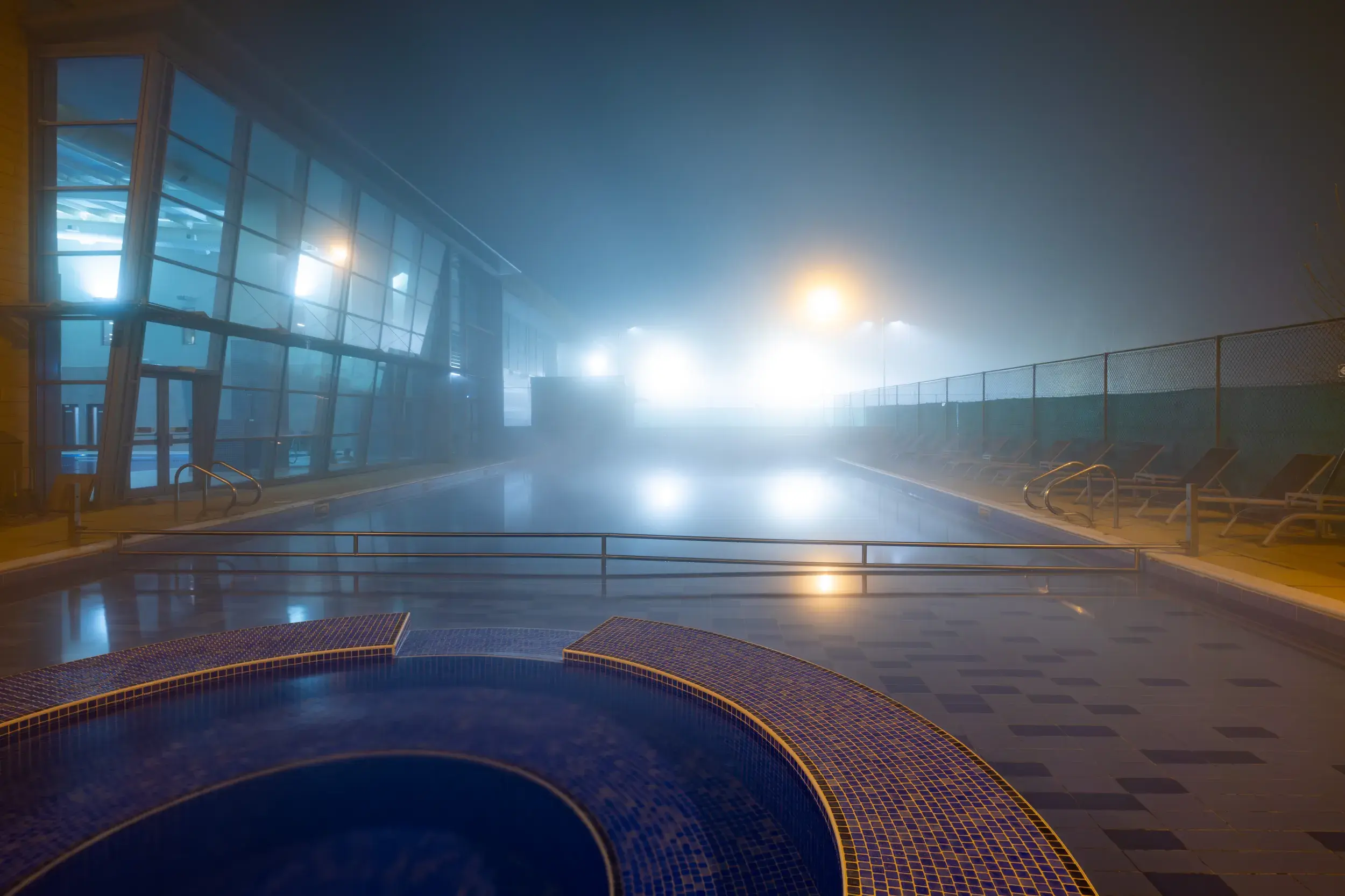 An atmospheric view of the outdoor swimming pool at night