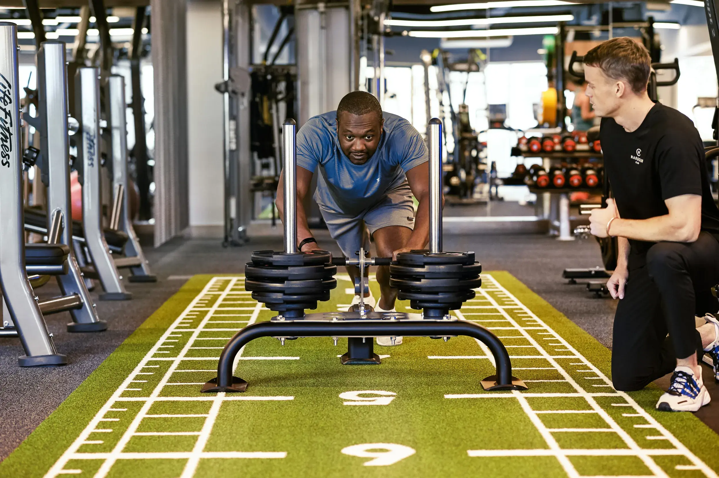 A man pushing a weighted sled
