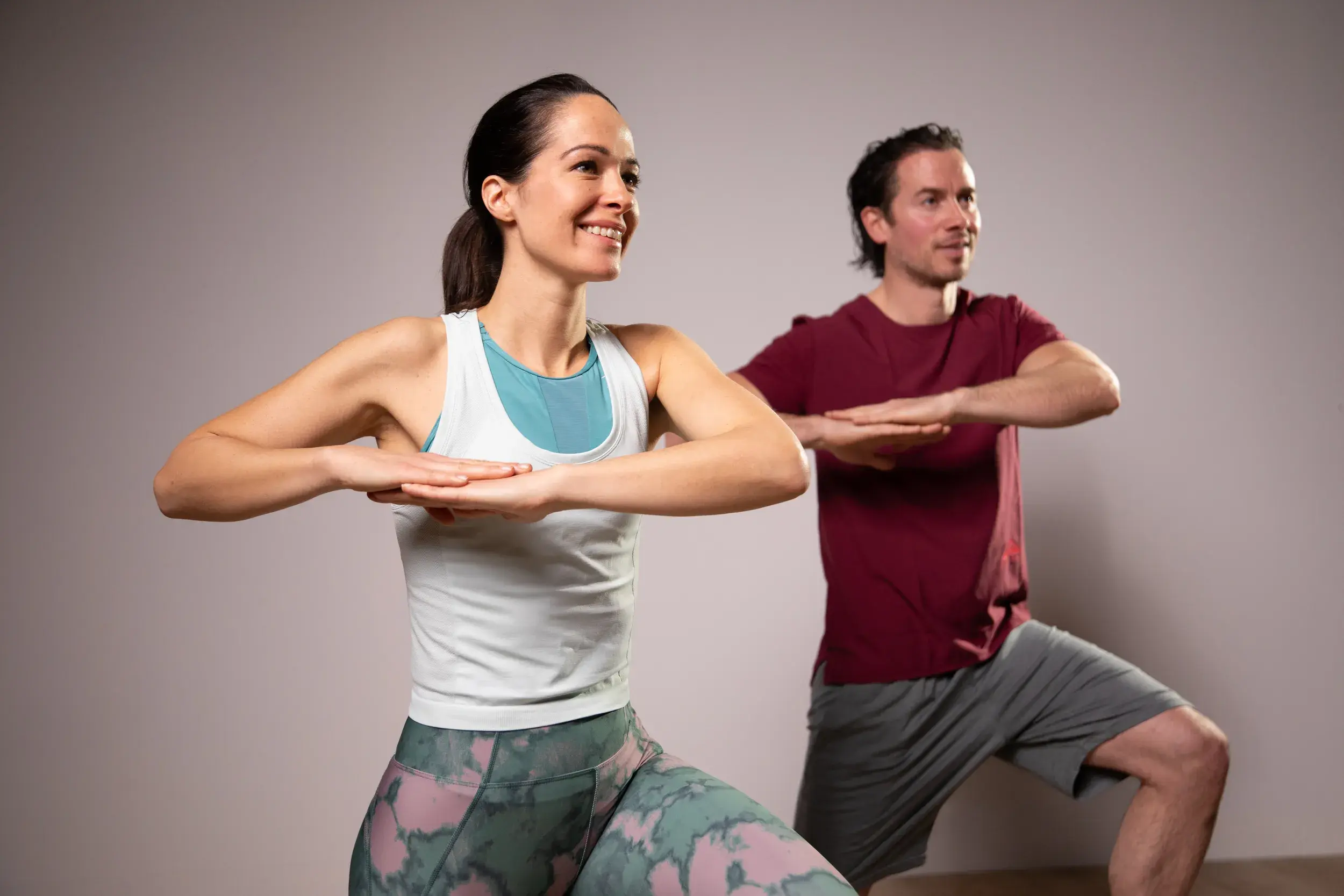 A man and woman doing a yoga pose
