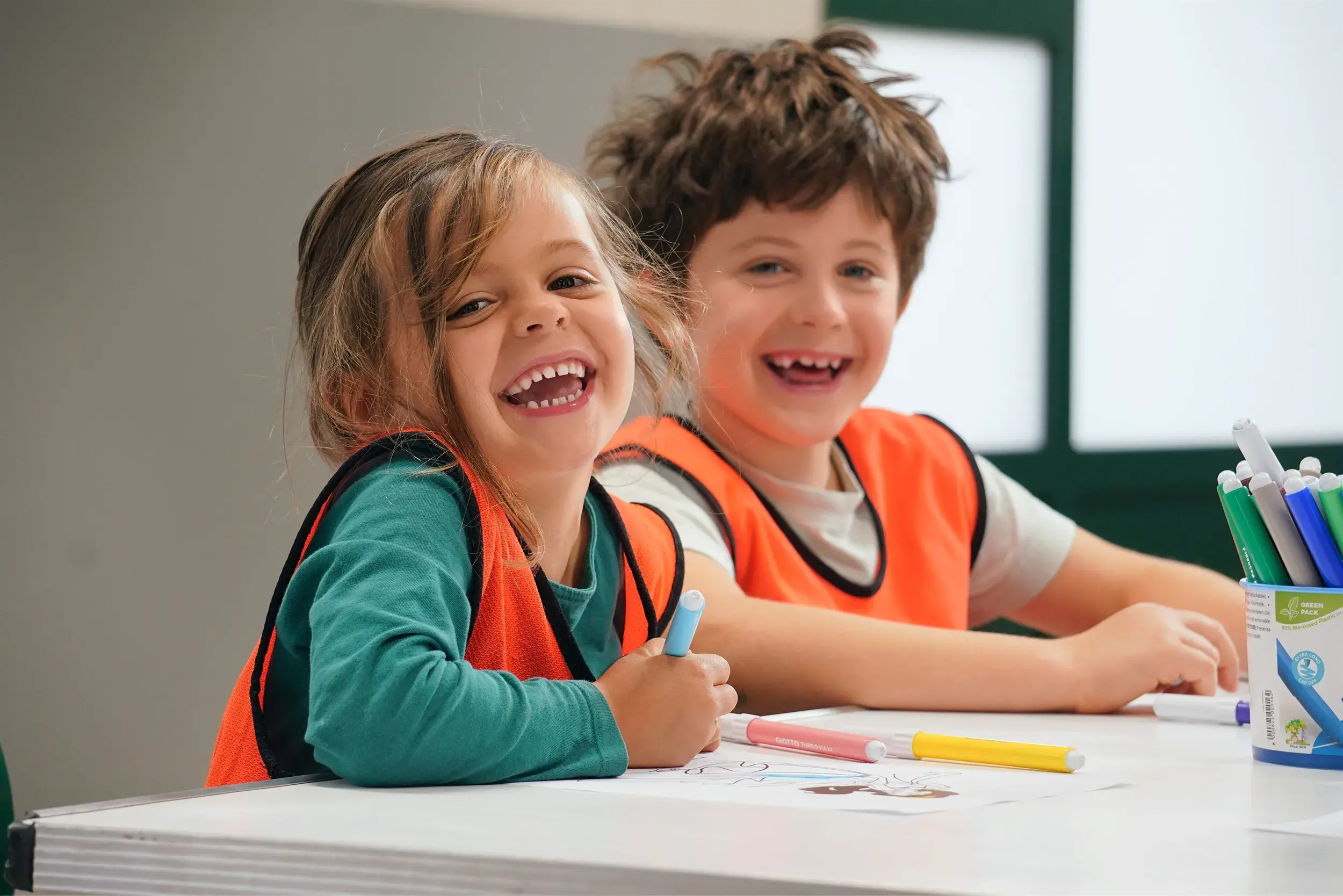 Kids in aprons sat at a craft table.