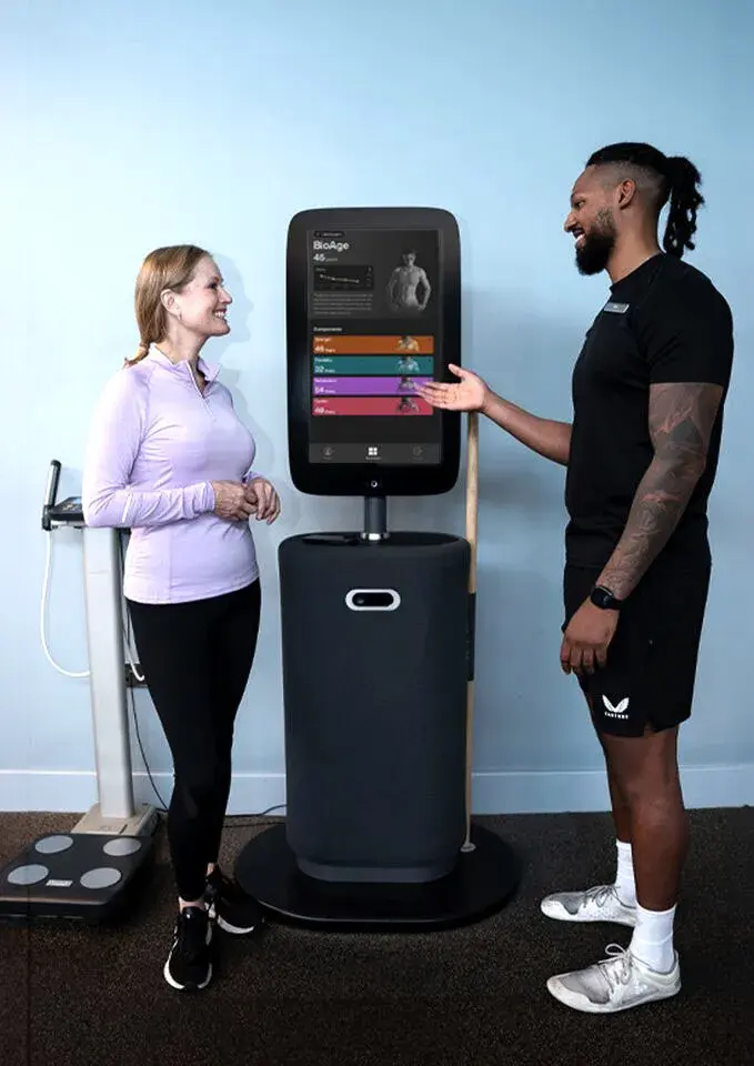 A personal trainer explaining the bodyhub to a member