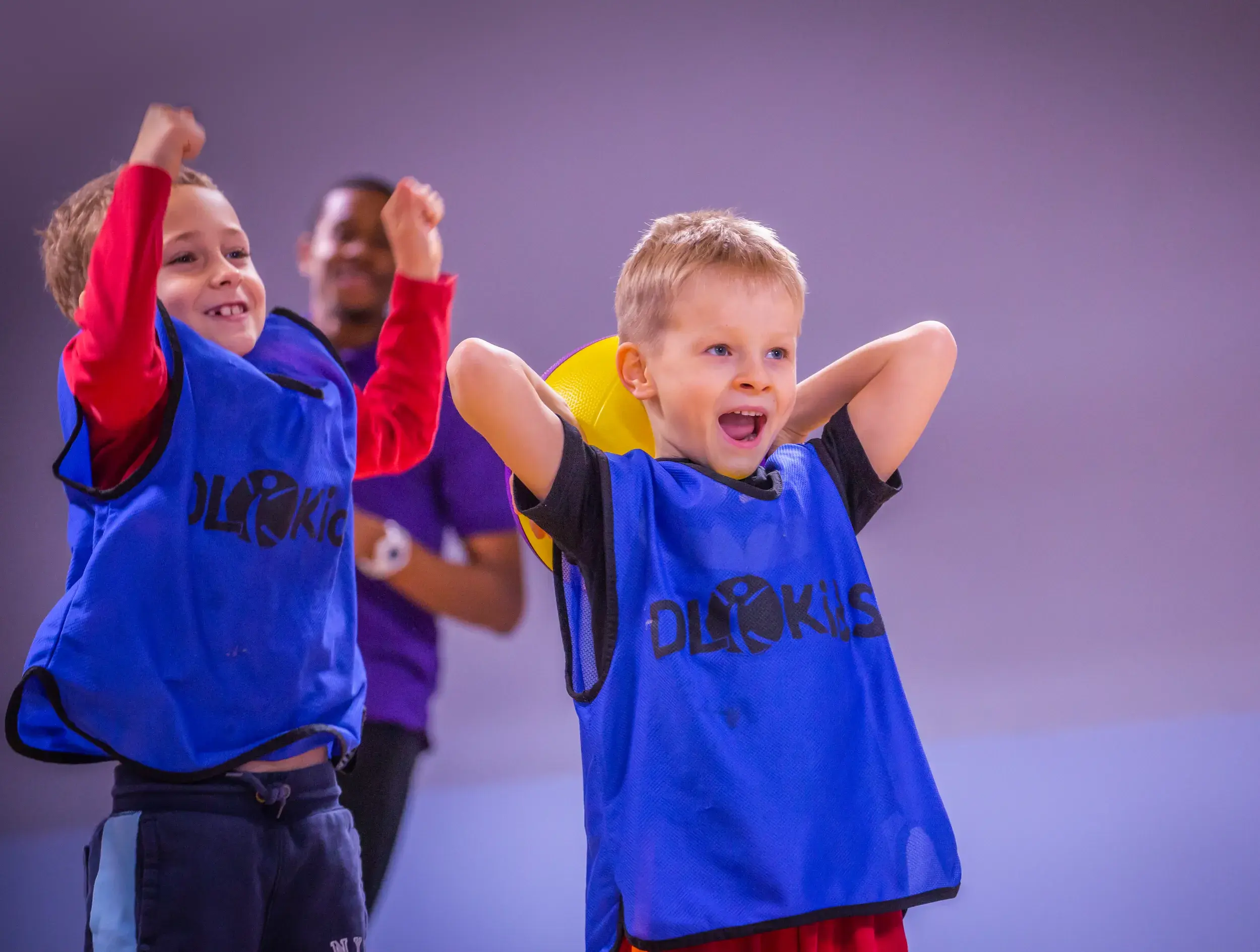 Children in DL Kids vests playing basketball