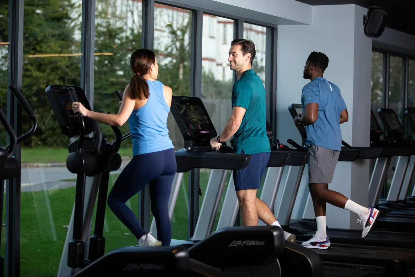 People working out on treadmills and cross trainers
