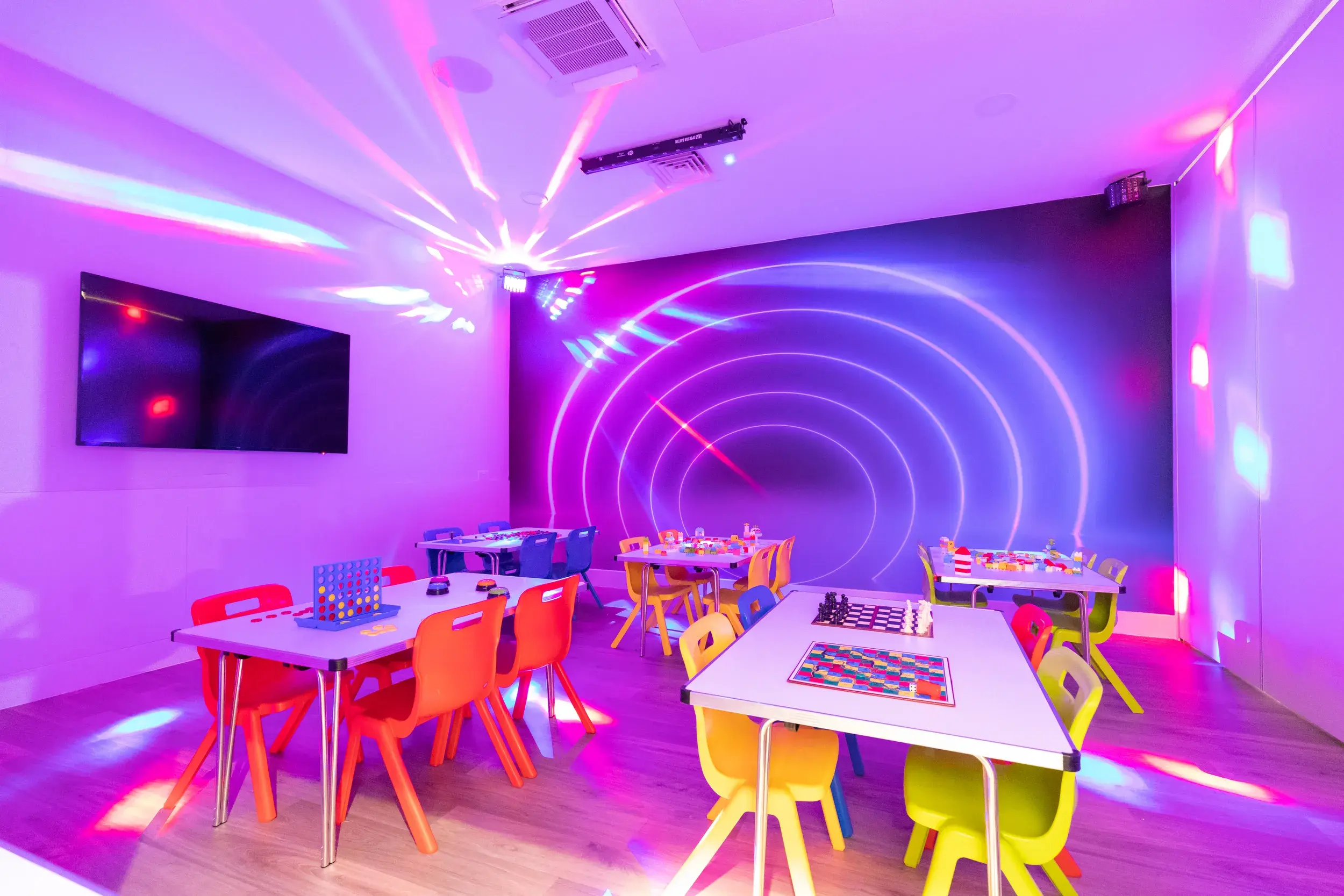 Board games set out on tables in the DL Kids room