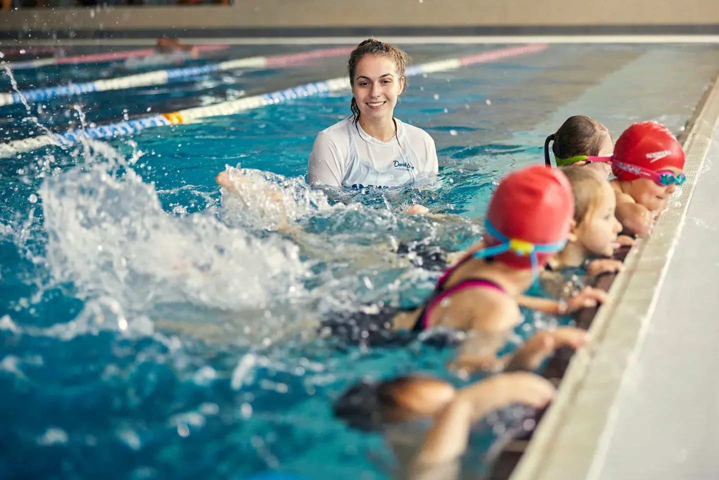 A young child being taught to swim by a David Lloyd swim instructor