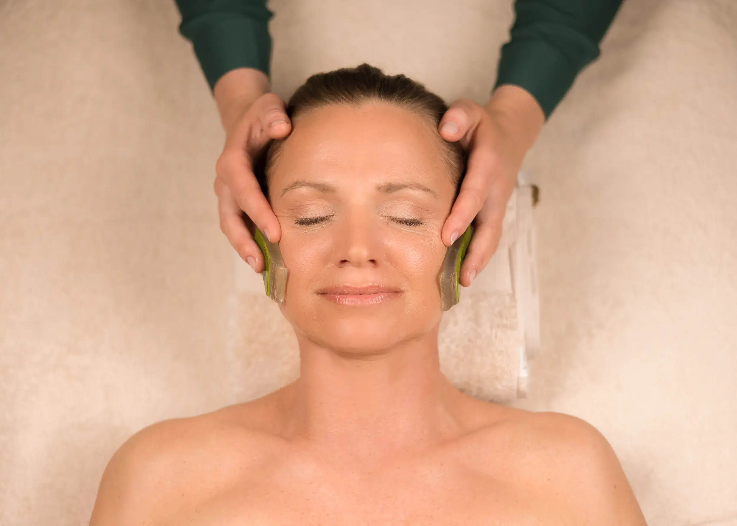 A woman receiving a facial treatment