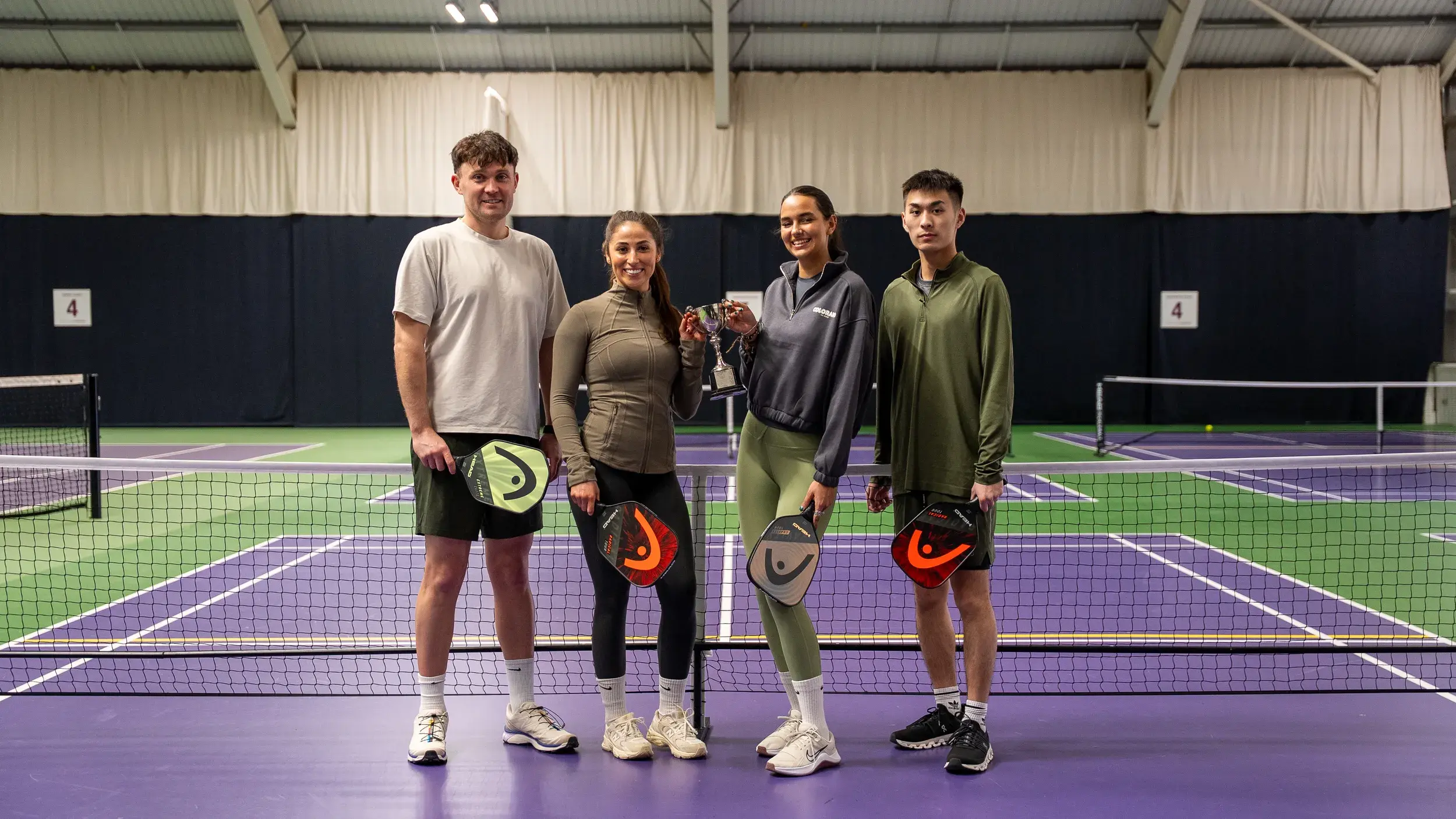 A group of teens playing Pickleball
