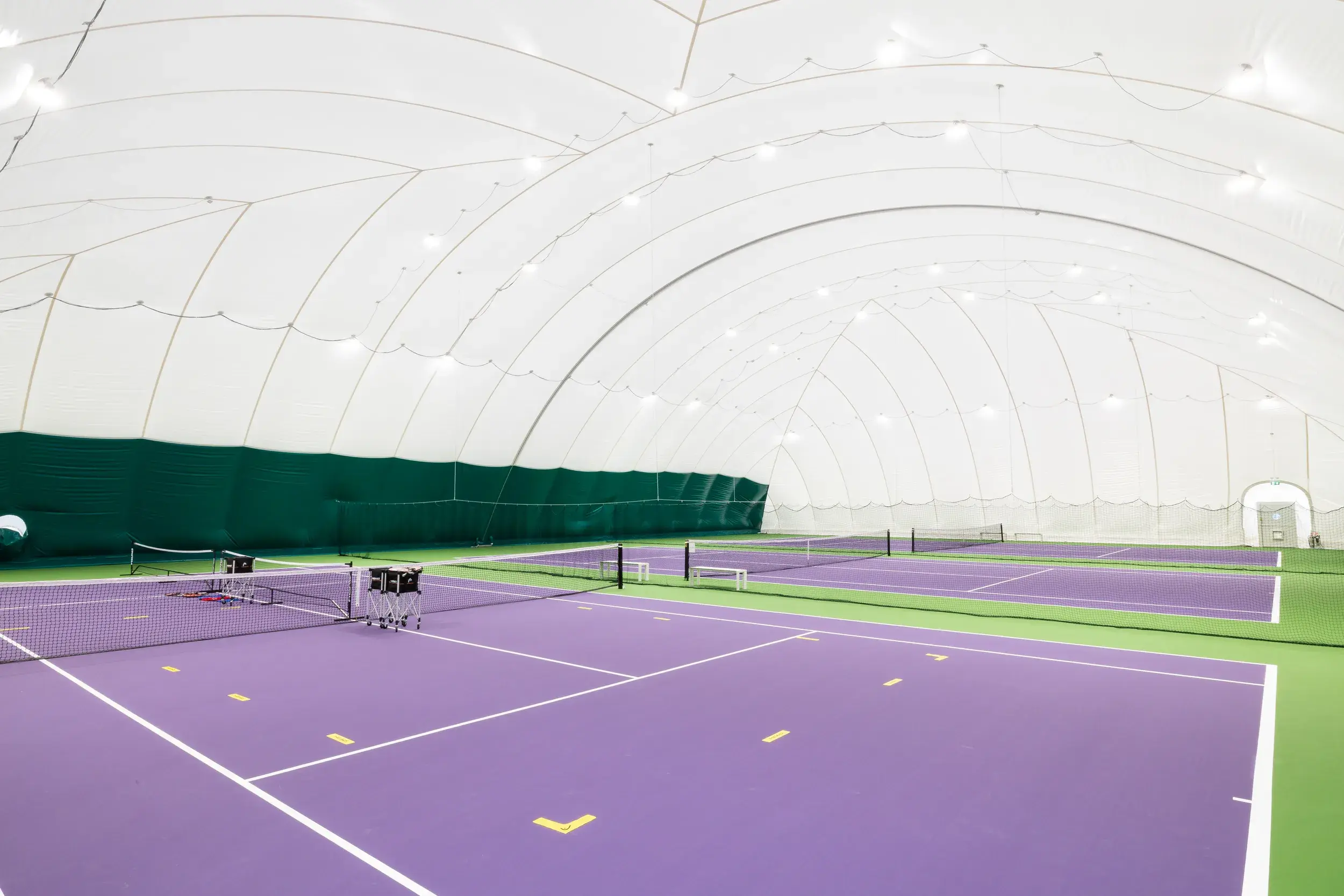 outdoor tennis court with tennis dome