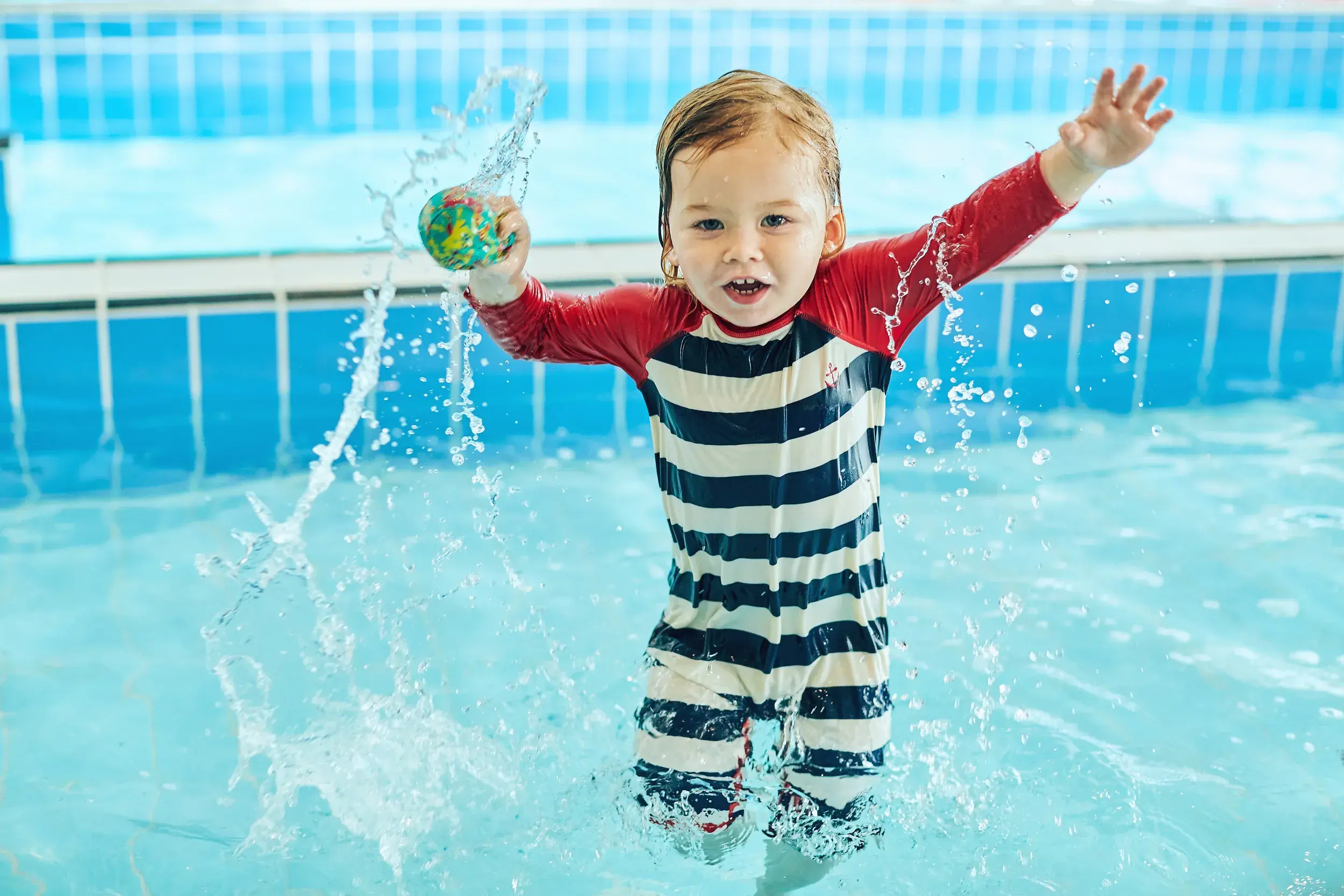 A young child playing in the splash pool