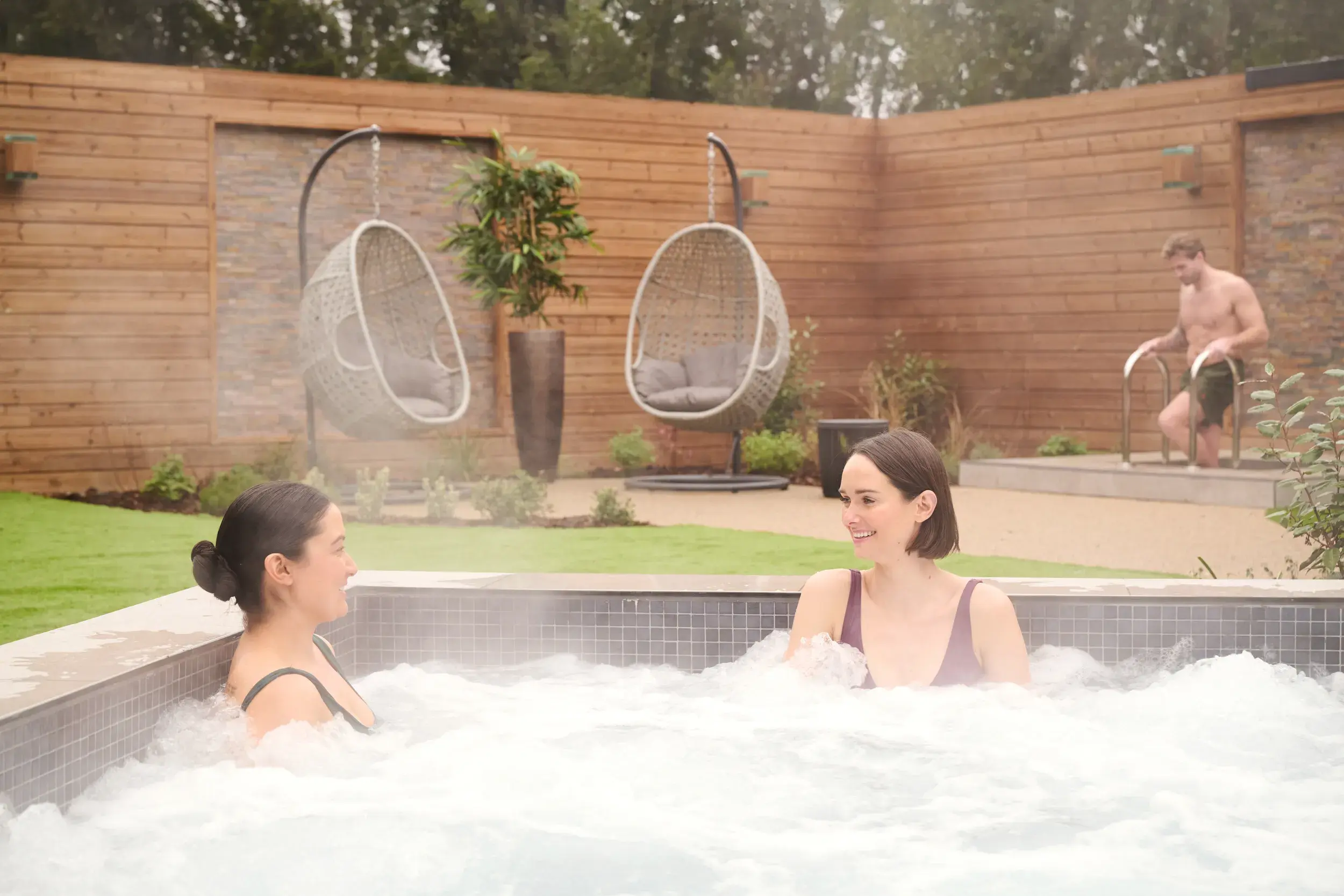 Two people in the outdoor hydro pool