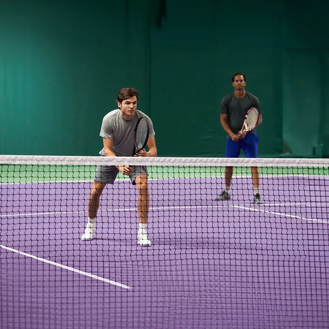 Two people playing a tennis match