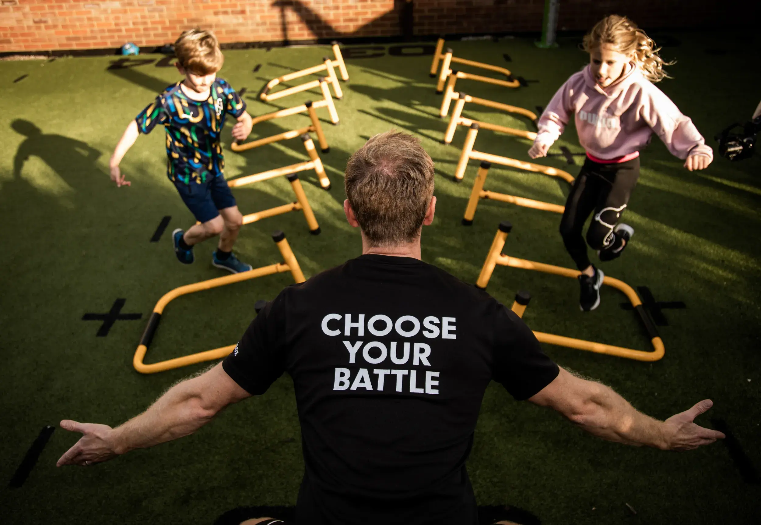 A Battlebox instructor encourages kids as they jump towards him.
