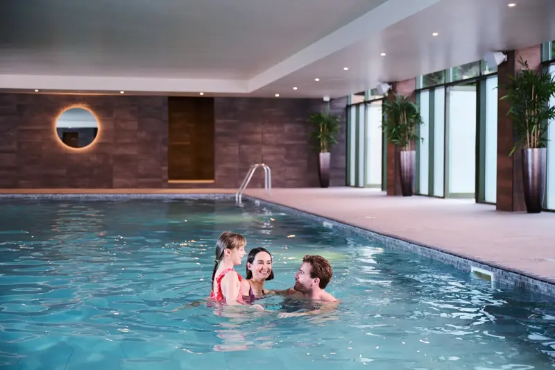 A family playing in the swimming pool